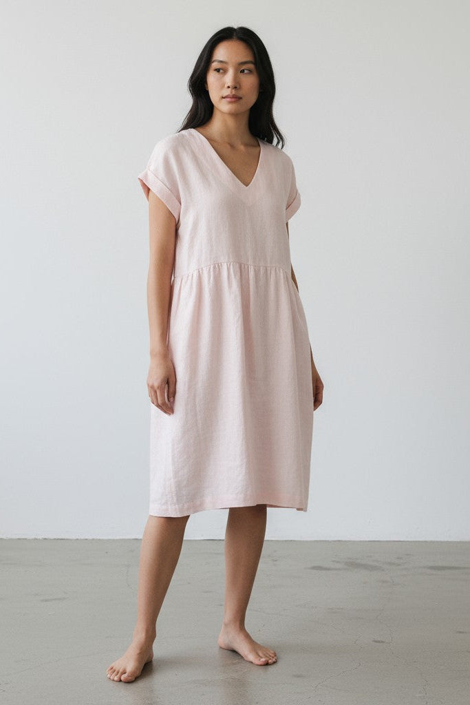 Alice linen dress – playful pose, natural drape, looking side