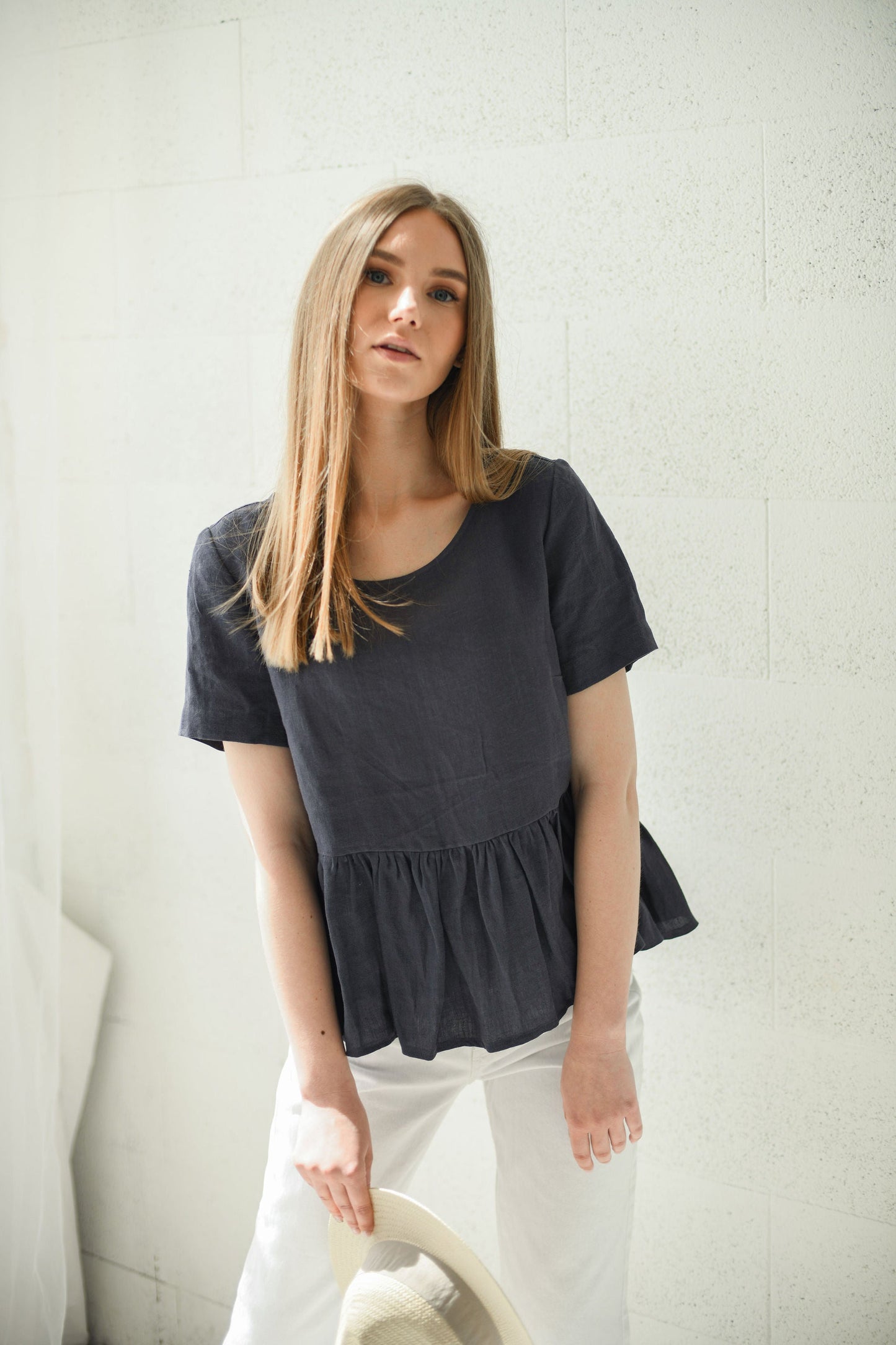 Anthonette black linen tank top in natural light leaning left handmade linen top slow fashion