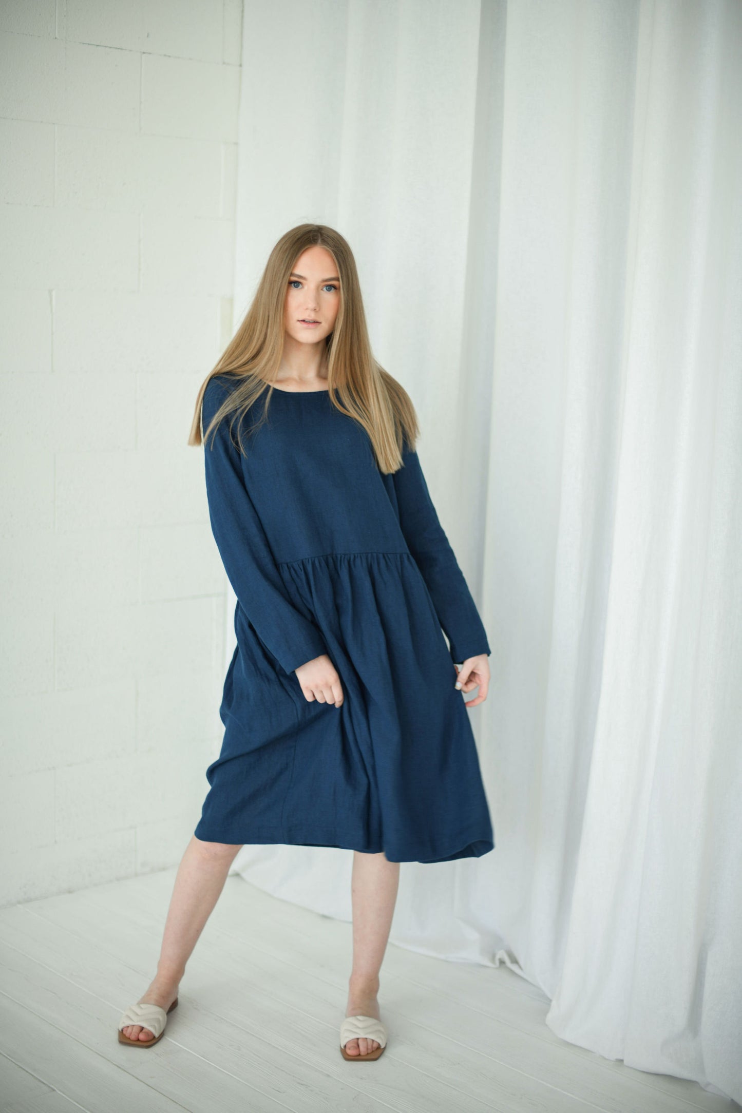 Model wearing relaxed long-sleeve linen dress, front view