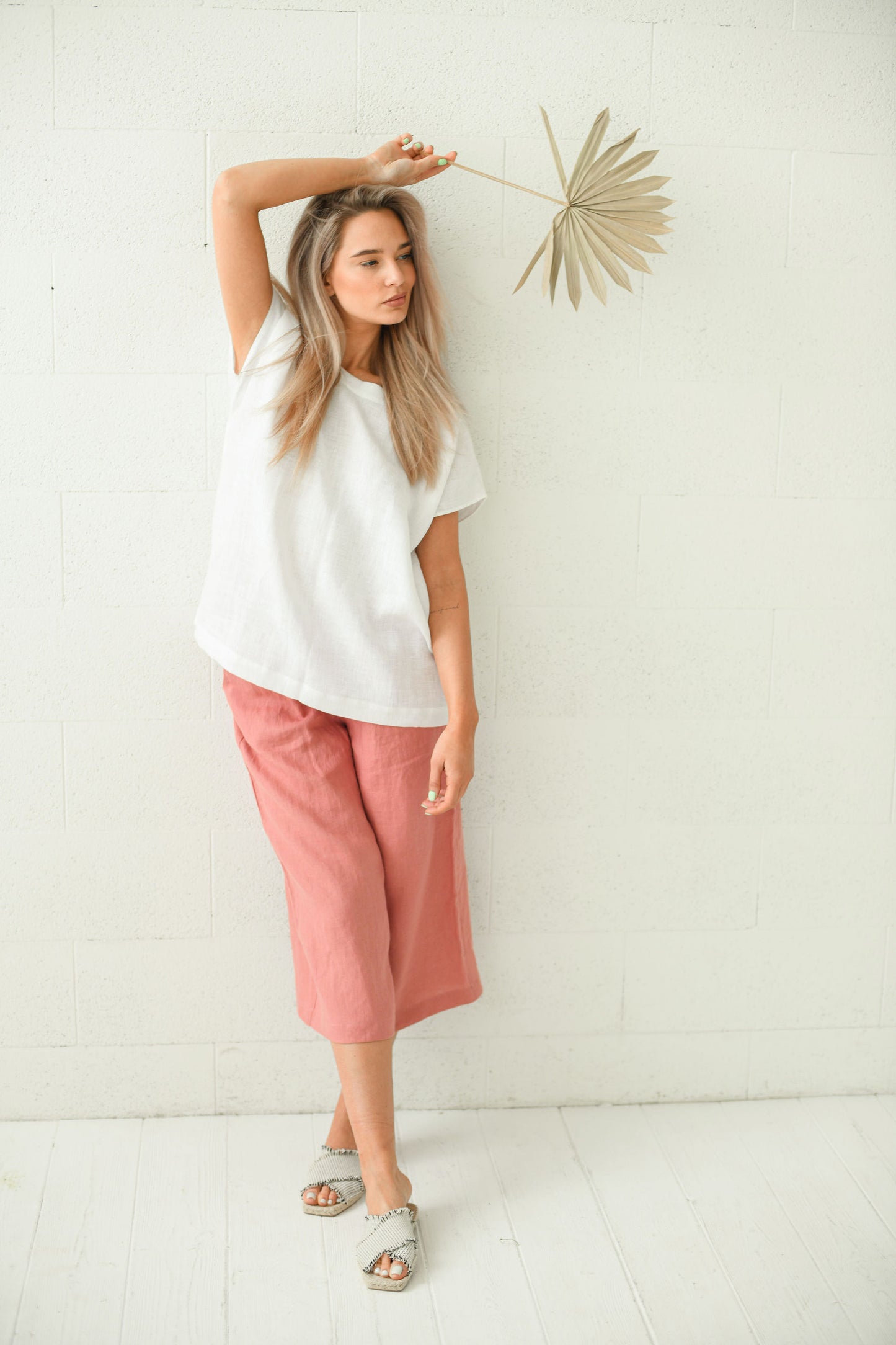 White linen top standing pose styled with pink culottes, handmade linen top slow fashion