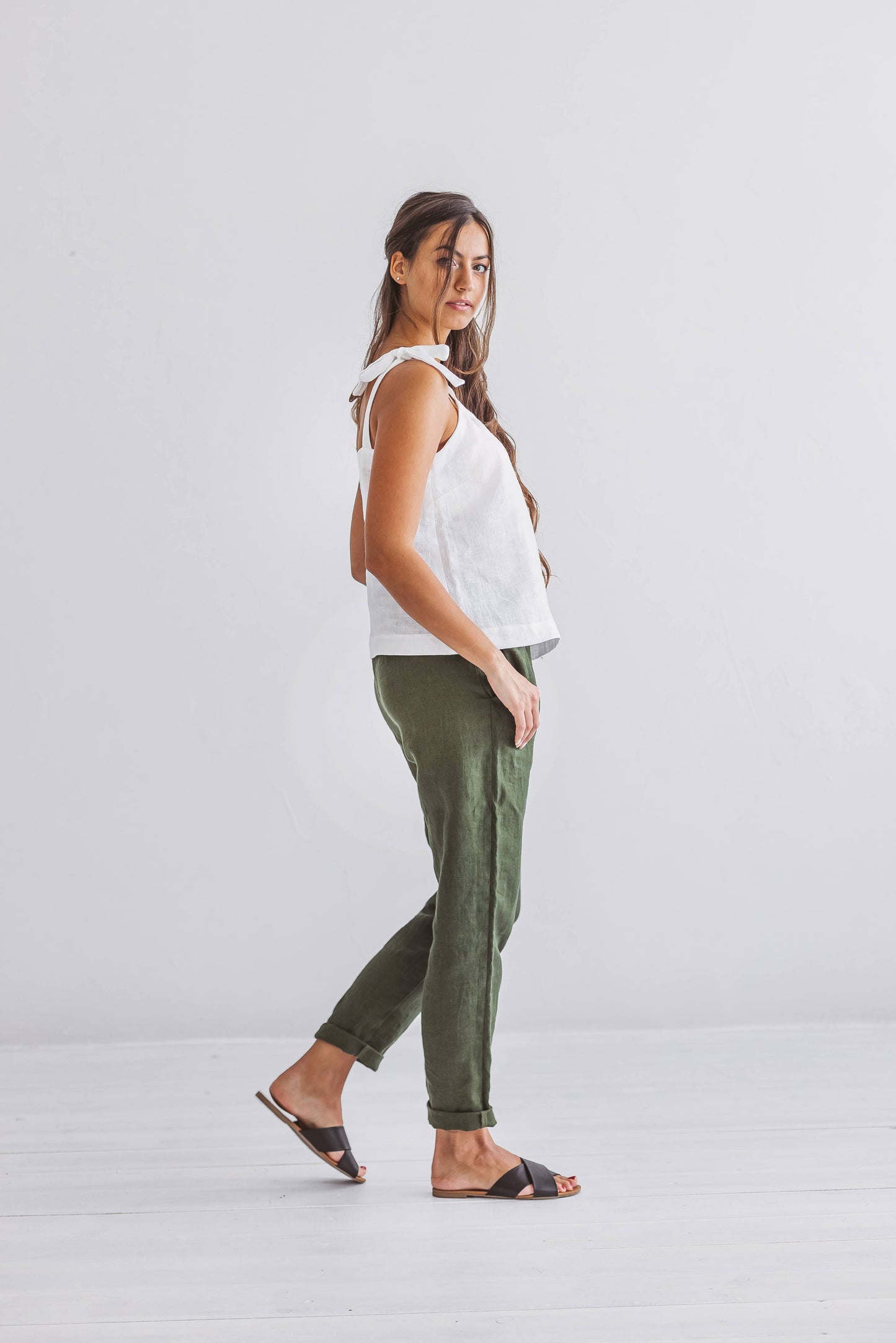 Forest green linen pants side view showing straight-leg cut, handmade linen pants slow fashion
