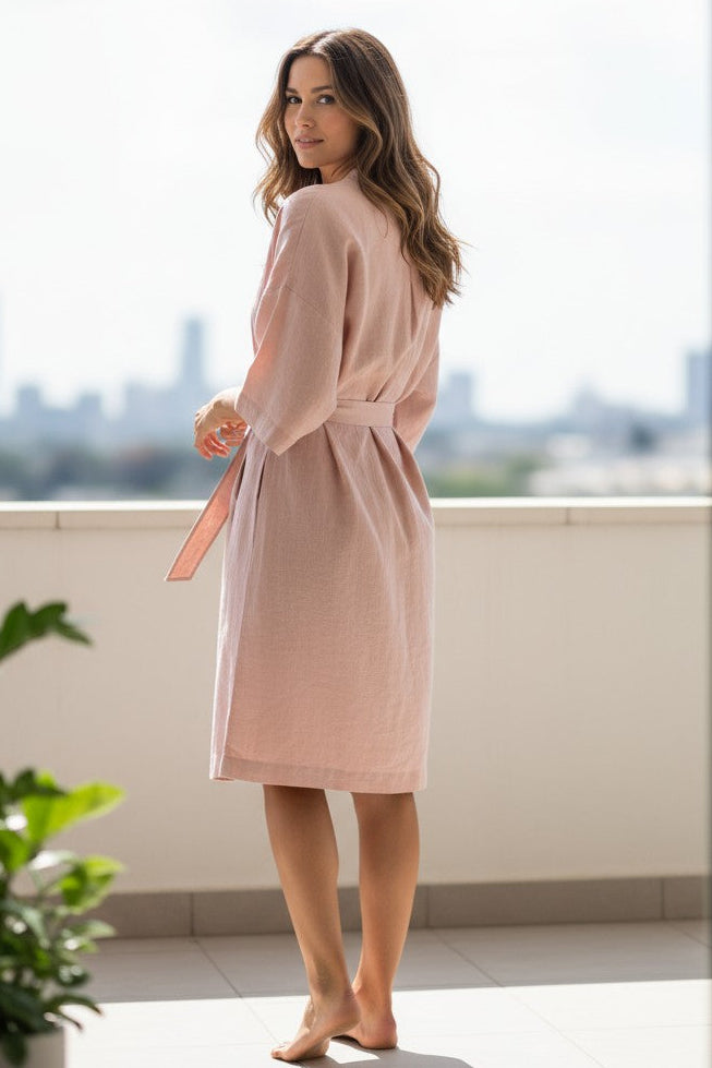 Model wearing the Teresa linen robe shown from the back in a relaxed pose
