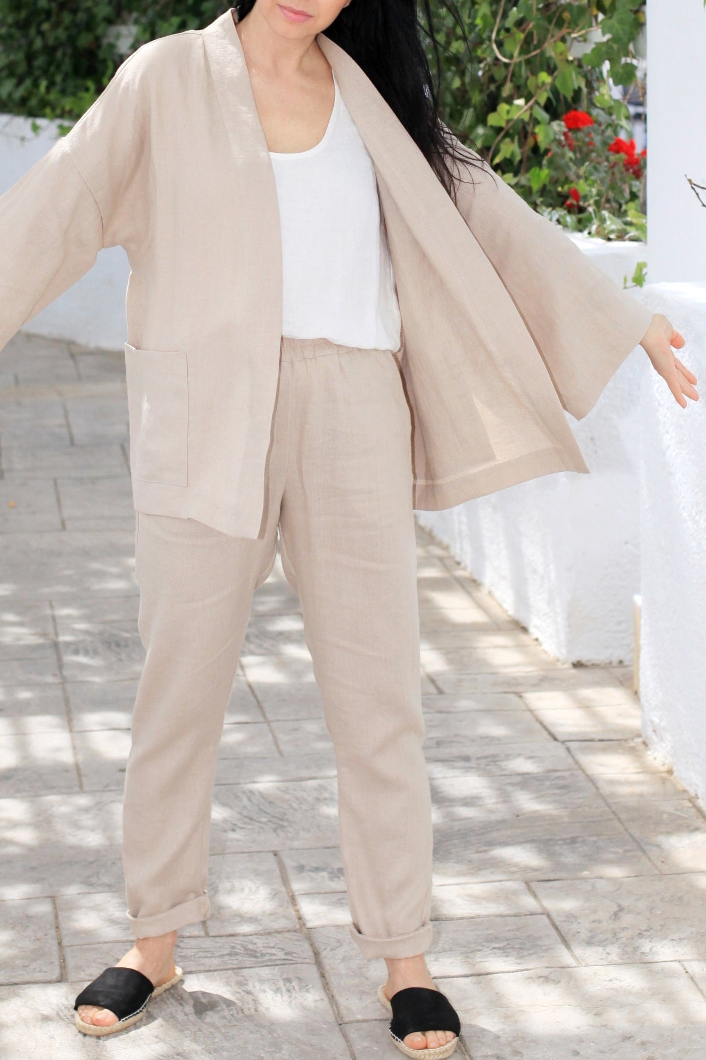 Woman wearing a beige outfit with a white background