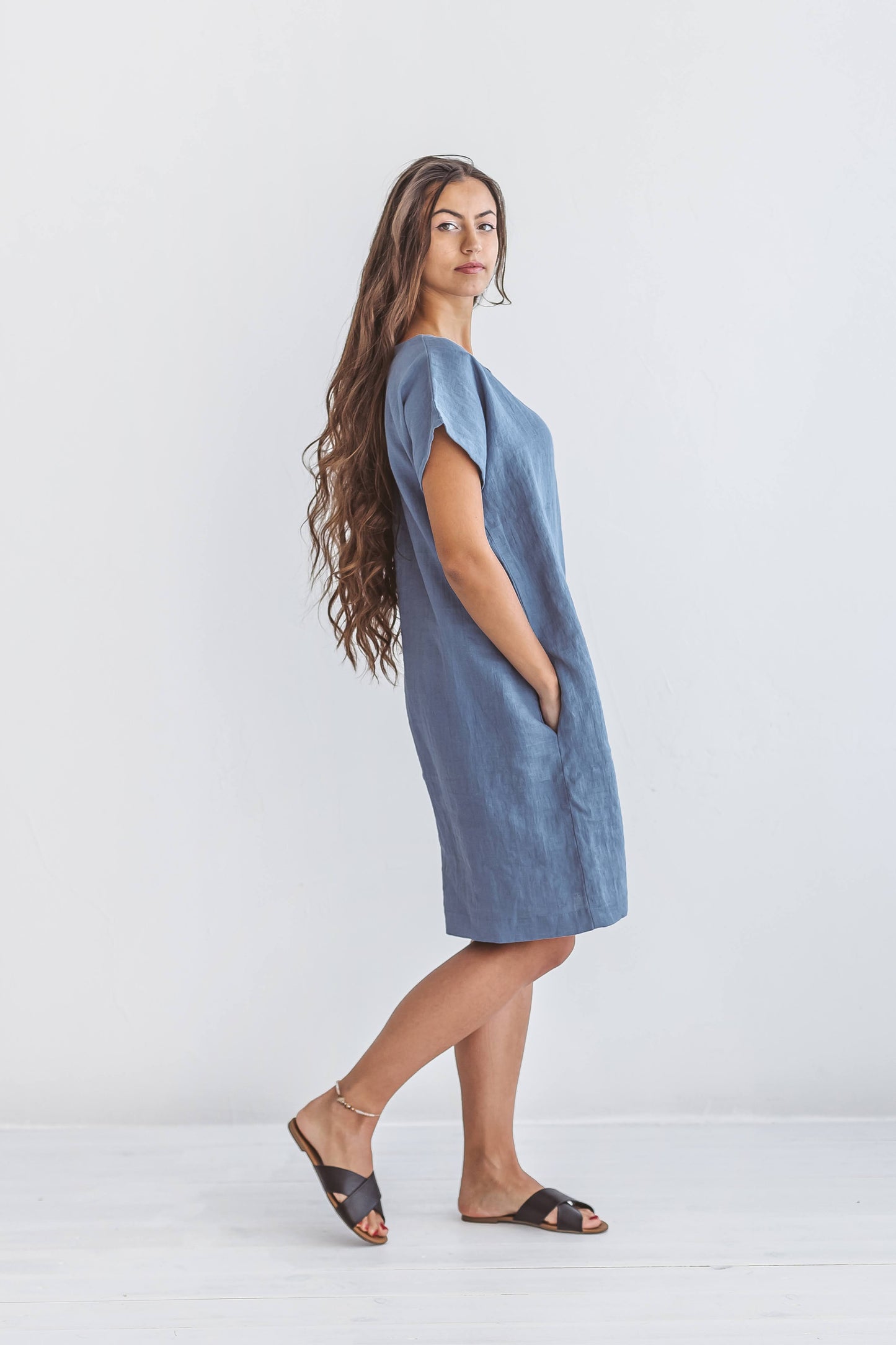 Woman wearing Diane linen dress in a half-body closeup, handmade linen dress slow fashion