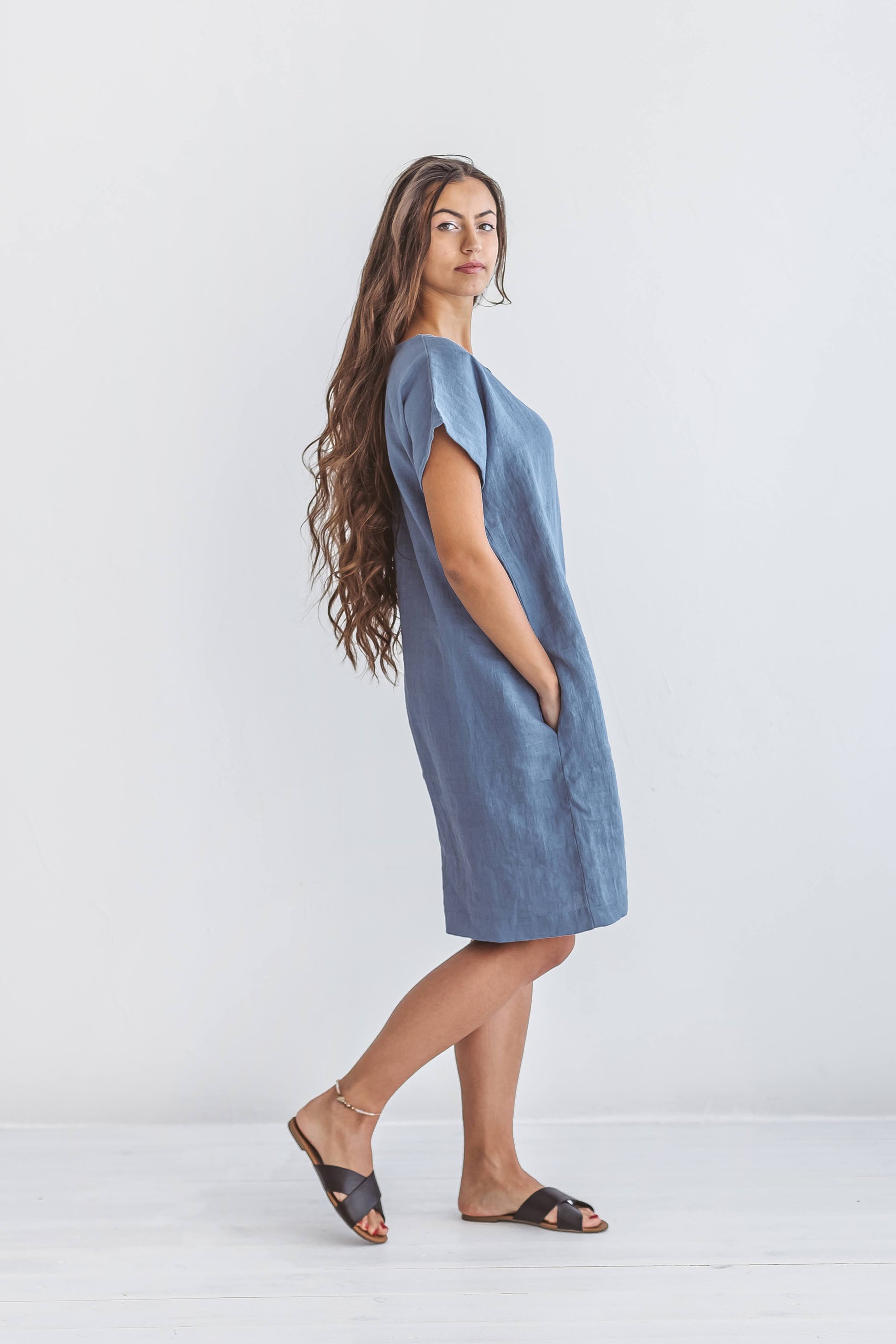 Woman wearing Diane linen dress in a half-body closeup, handmade linen dress slow fashion