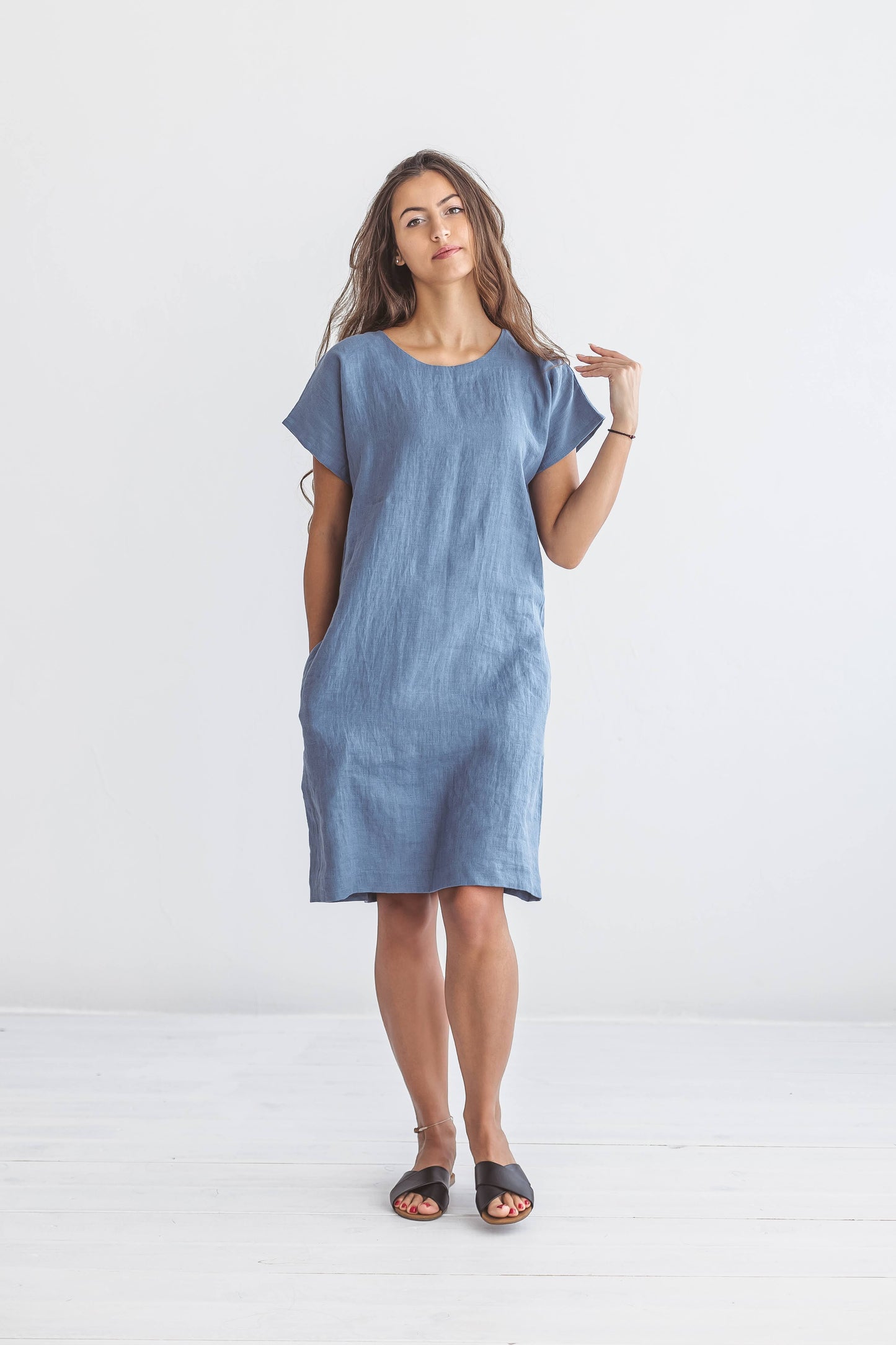 Full-body studio view of woman wearing Diane linen dress, handmade linen dress slow fashion