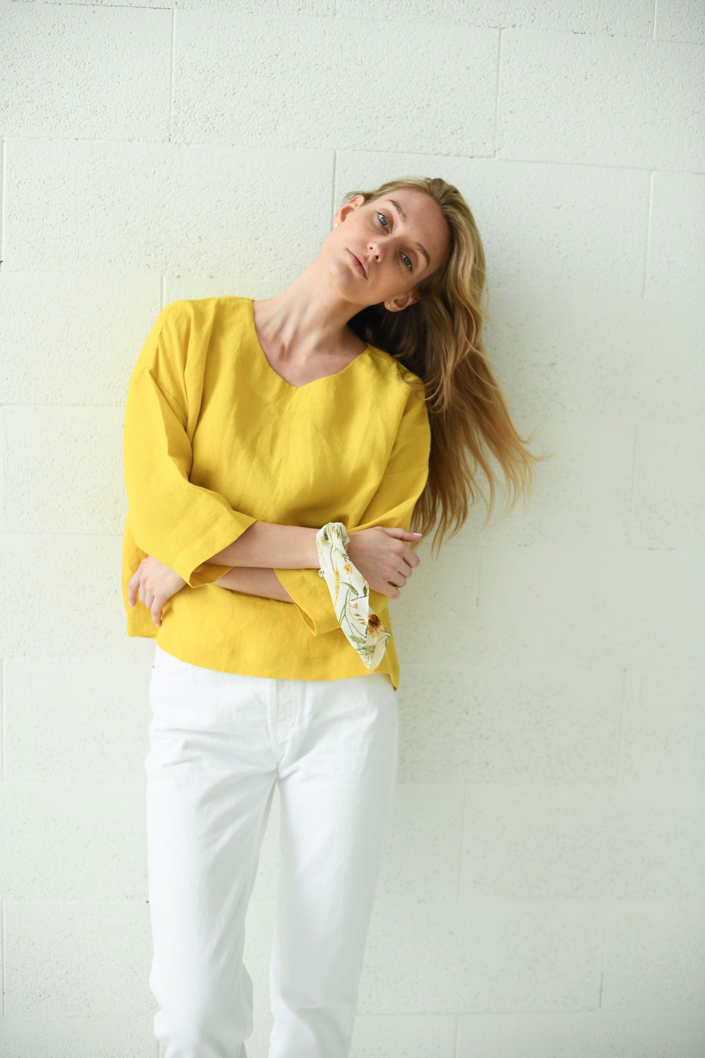 Yellow linen top side view with hands in pockets showing relaxed fit, handmade linen top slow fashion