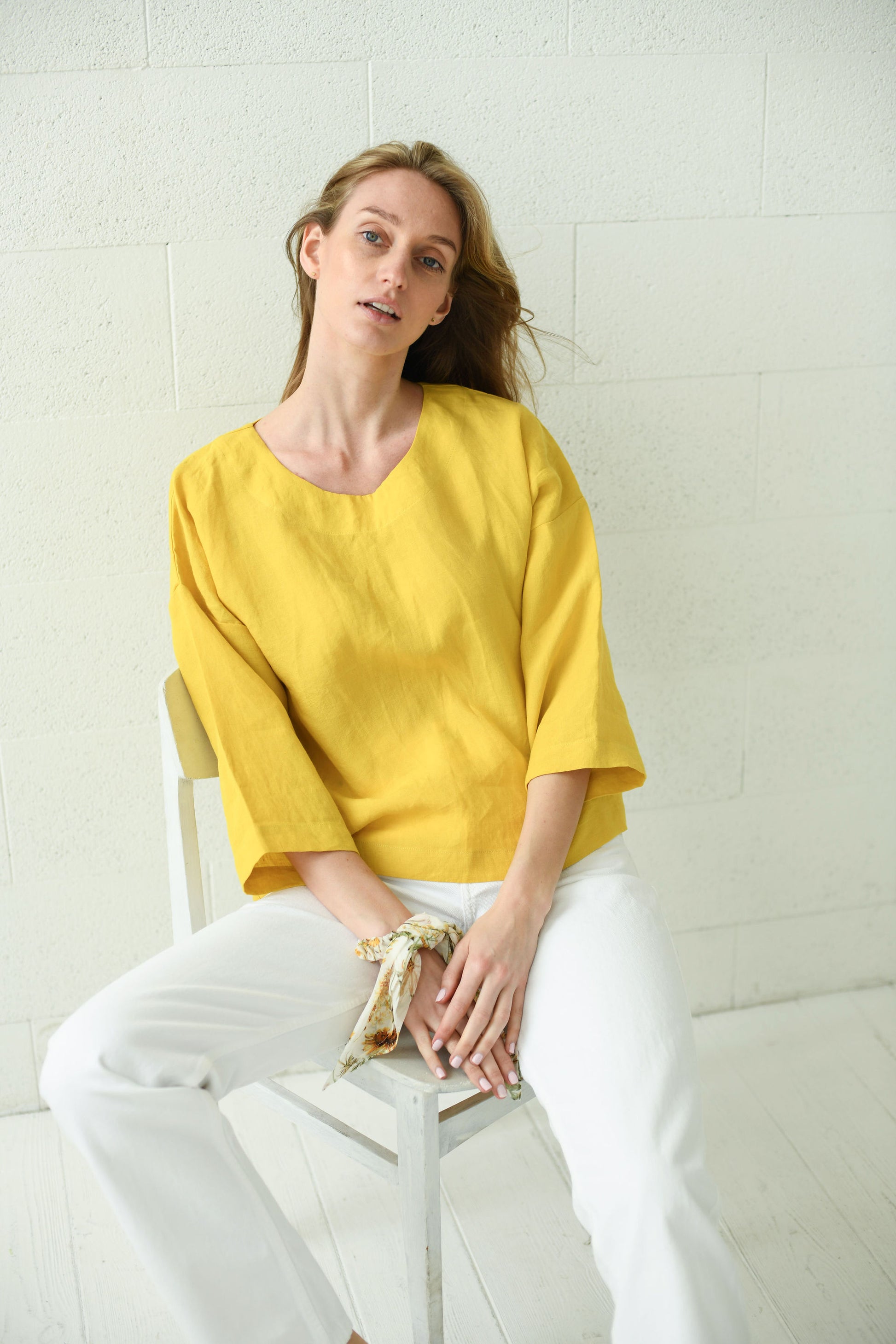 Yellow linen top relaxed fit front sitting view with sculpted sleeves, handmade linen top slow fashion