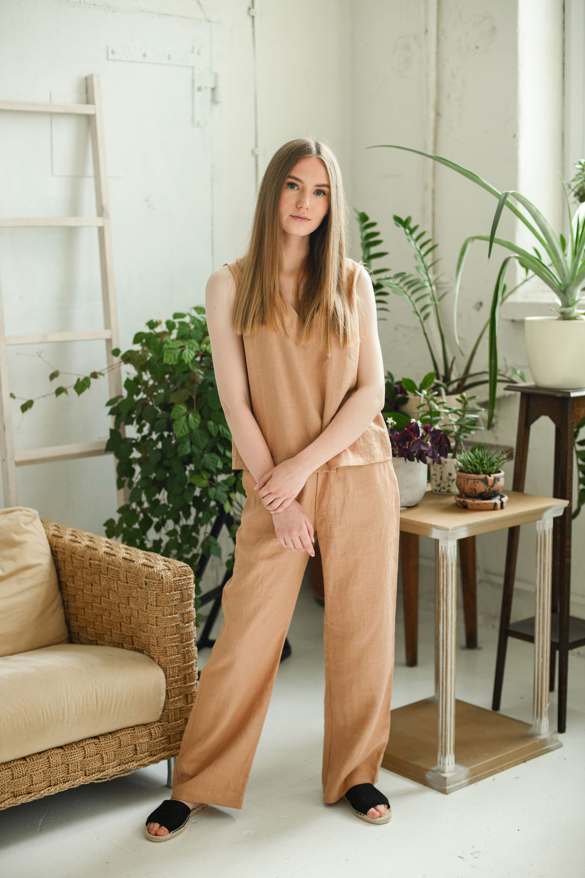 Caramel brown linen pants relaxed front pose with soft natural light, handmade linen pants slow fashion