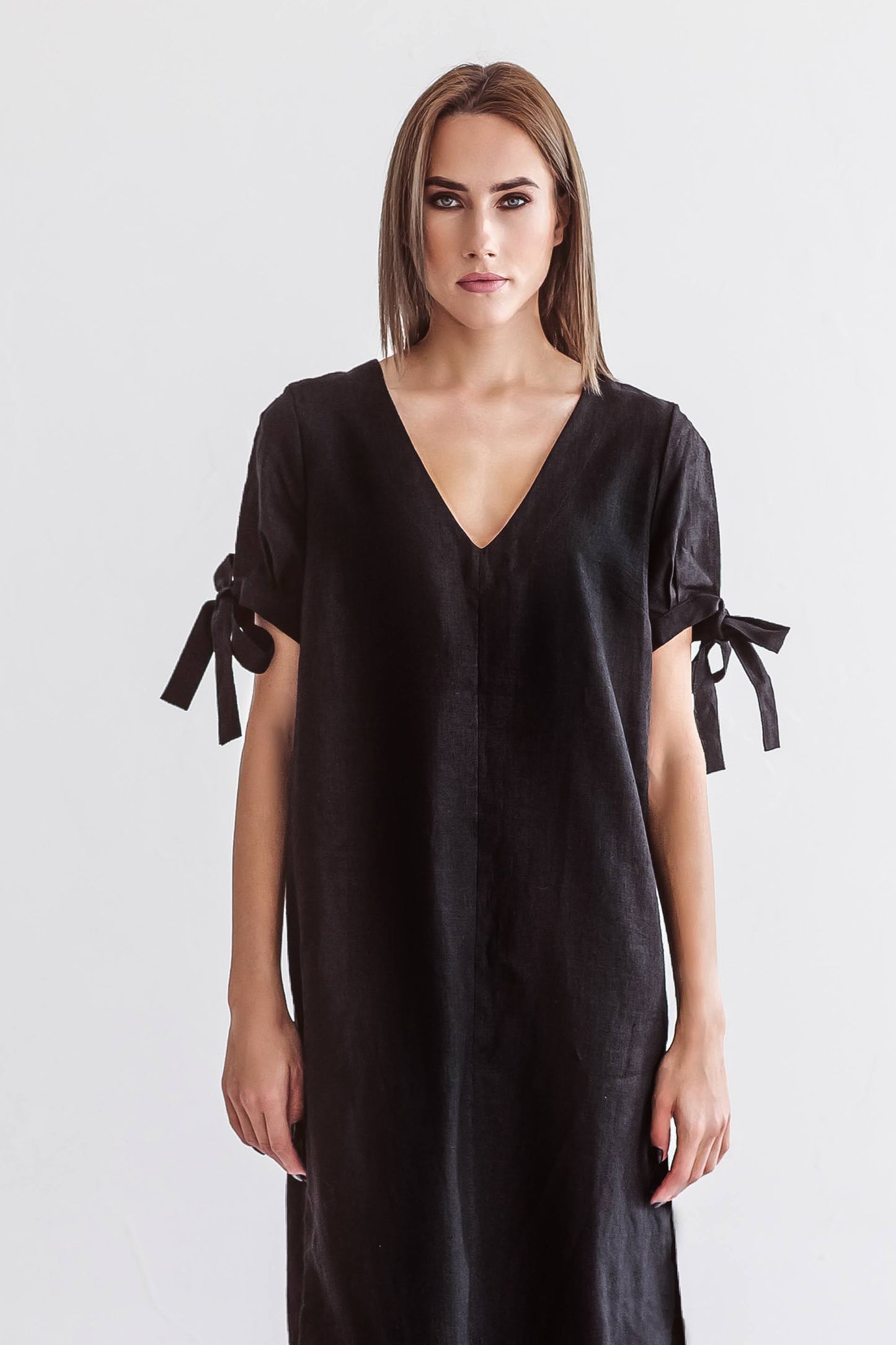 Black linen midi dress close front view with V-neck and tie-sleeve details, handmade linen dress slow fashion