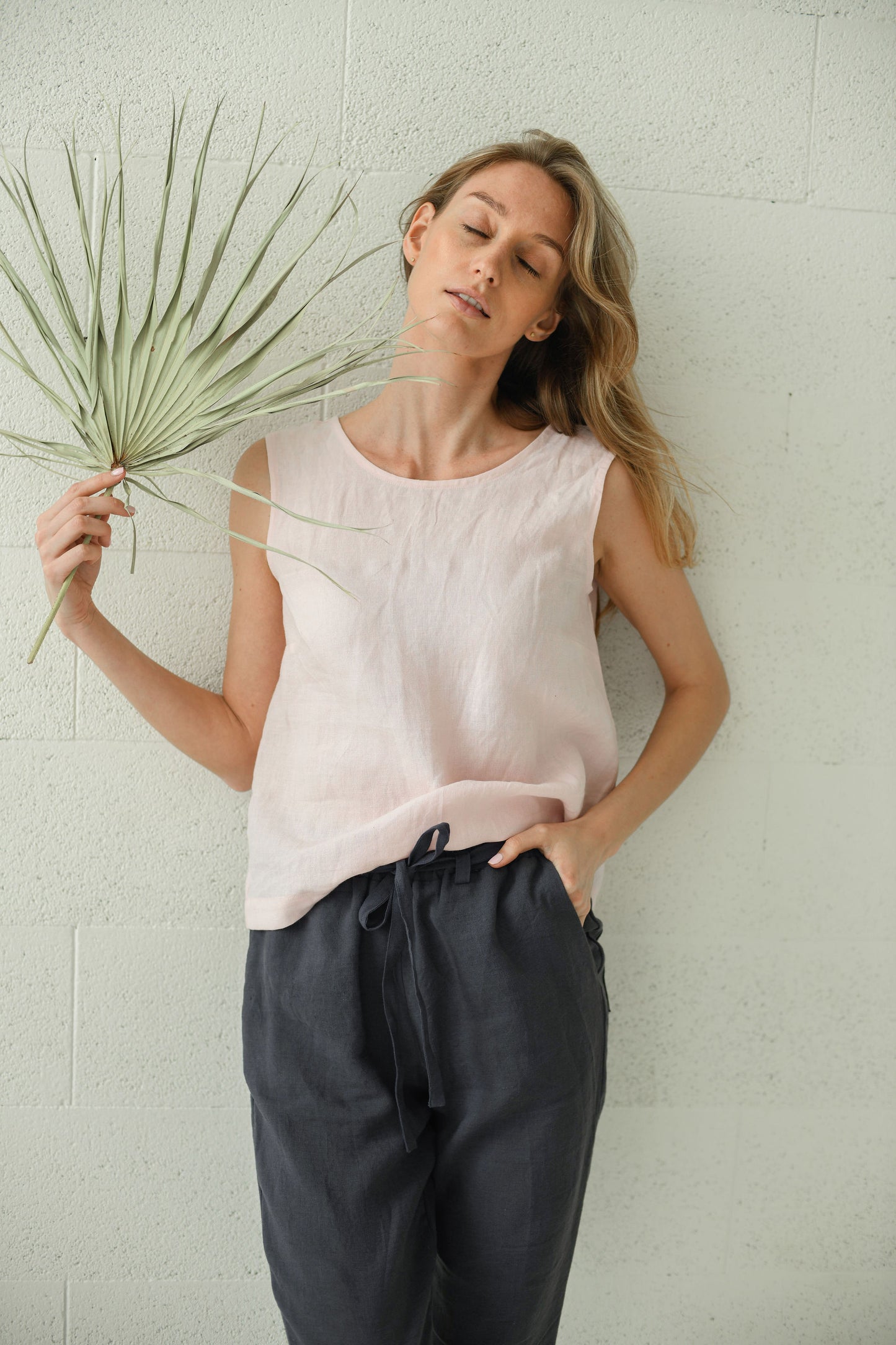Black linen pants front view showing relaxed silhouette and drape, handmade linen pants slow fashion