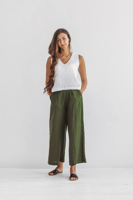 Forest green linen pants front view standing relaxed pose showing wide-leg cut, handmade linen pants slow fashion