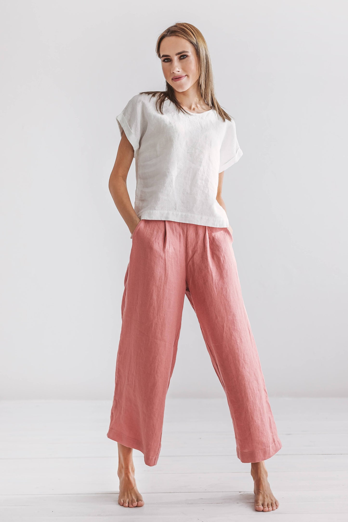 Salmon linen pants front view standing relaxed pose showing wide-leg cut, handmade linen pants slow fashion