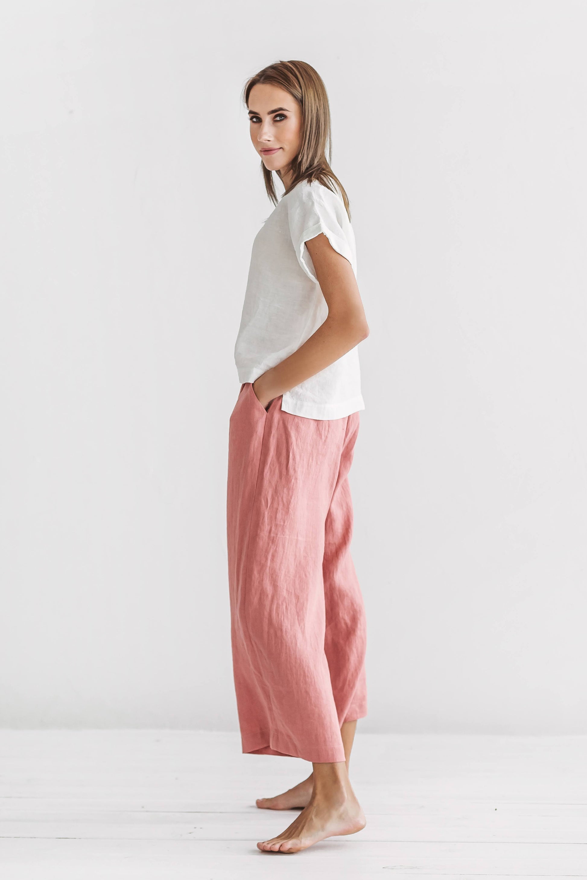 Salmon linen pants full side view showing airy fabric and comfortable wide-leg cut, handmade linen pants slow fashion