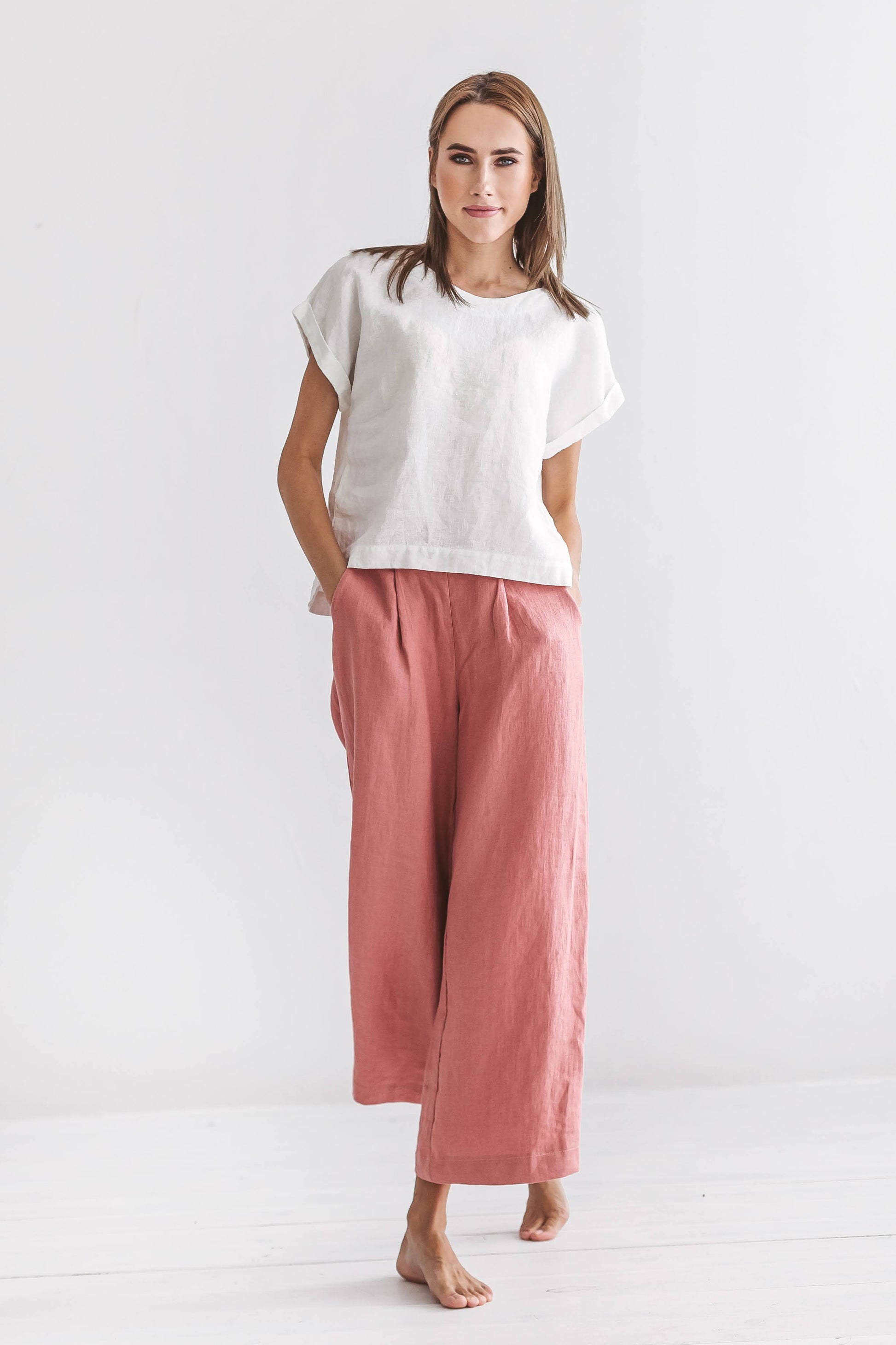 Salmon linen pants showing wide-leg shape and soft movement in motion, handmade linen pants slow fashion