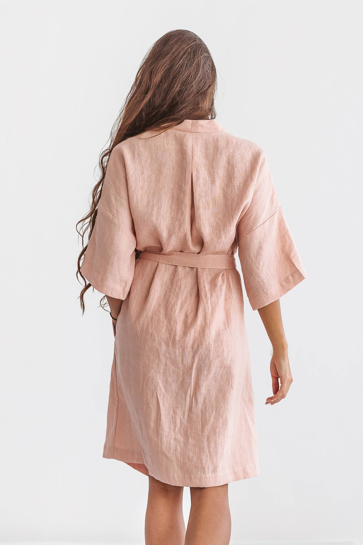 Pastel pink linen robe back view showing relaxed silhouette and wide sleeves, handmade linen robe slow fashion
