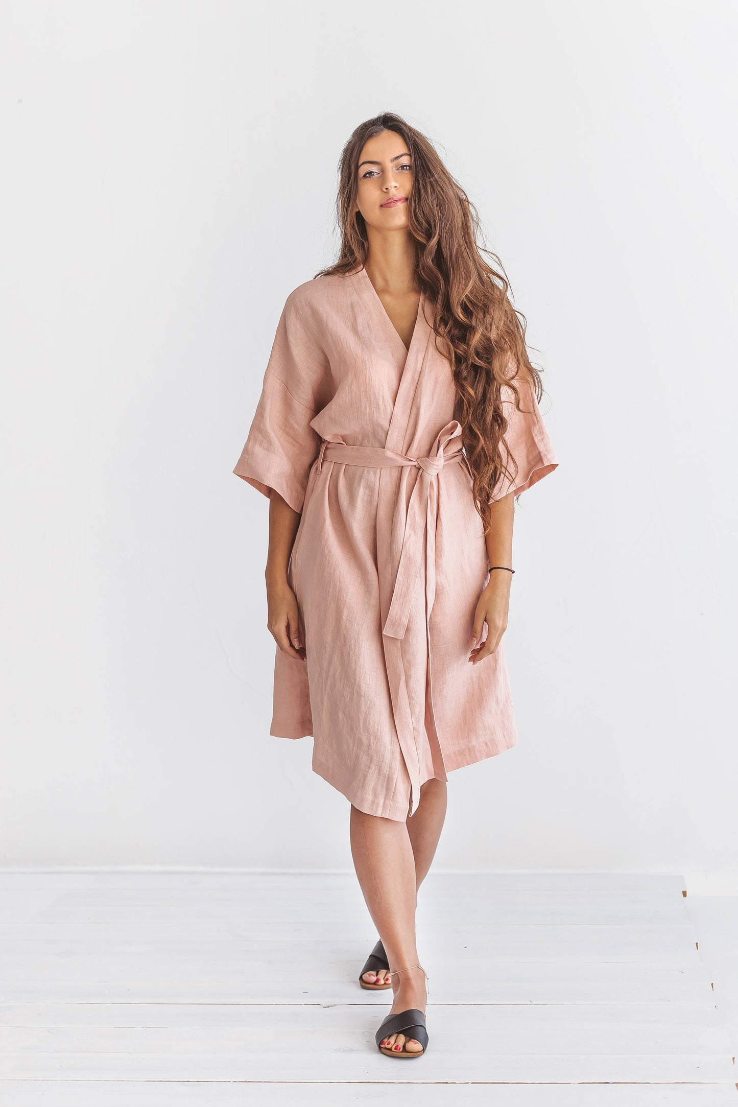 "Pastel pink linen robe front view standing relaxed pose showing kimono-style wrap, handmade linen robe slow fashion