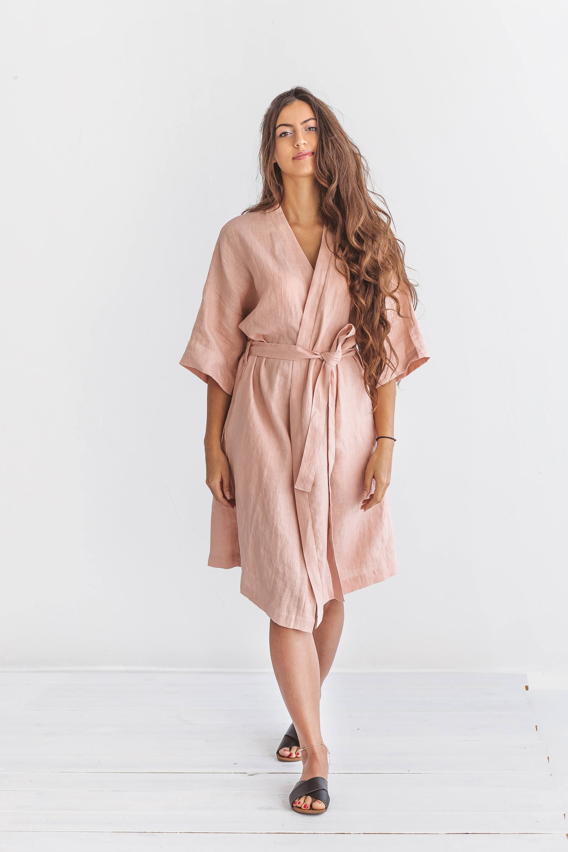 "Pastel pink linen robe front view standing relaxed pose showing kimono-style wrap, handmade linen robe slow fashion