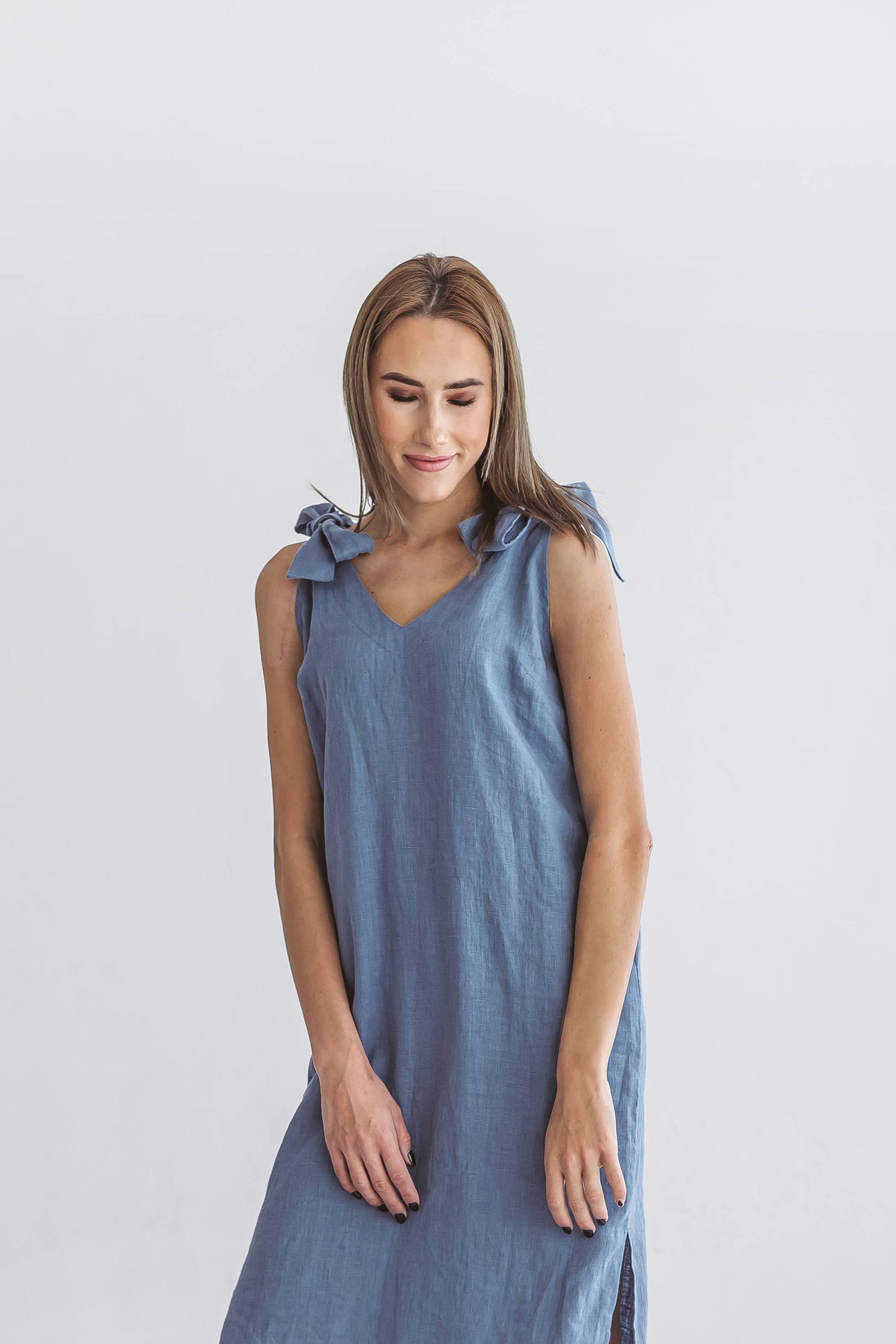 Jeans blue linen dress closer dynamic pose stepping forward showing minimalist design, handmade linen dress slow fashion