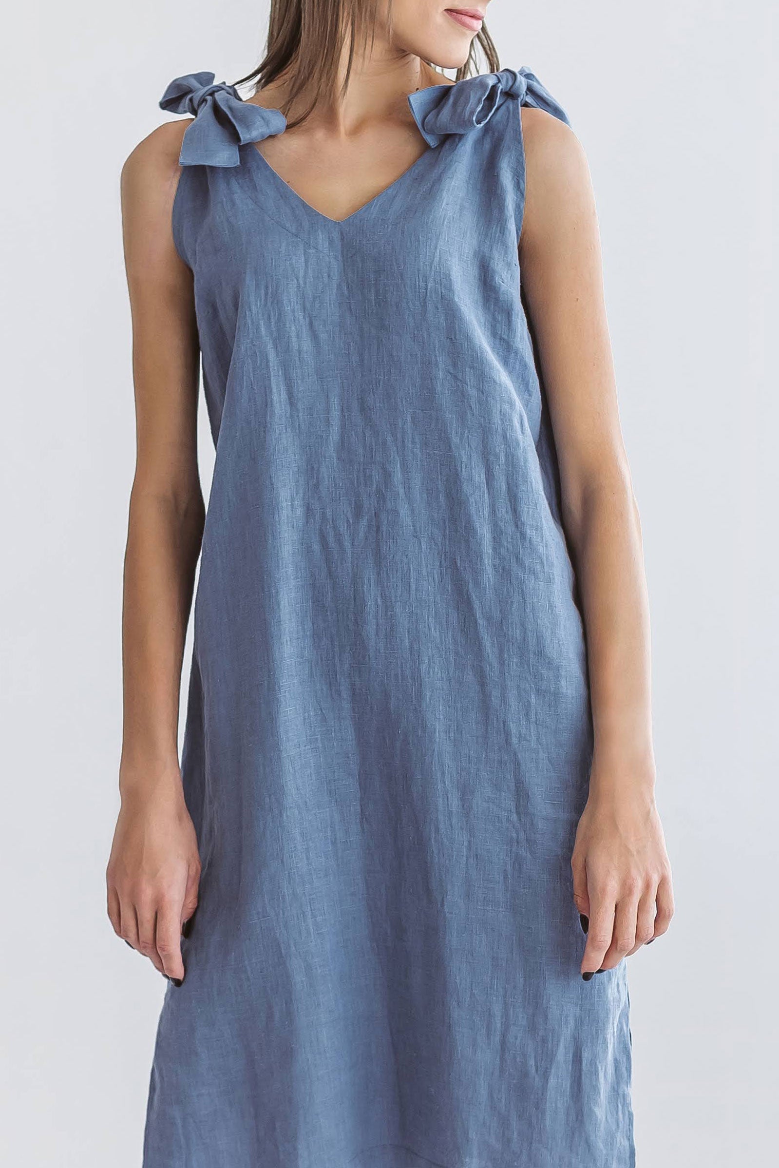 Jeans blue linen dress front view with relaxed posture showing sleeveless cut, handmade linen dress slow fashion