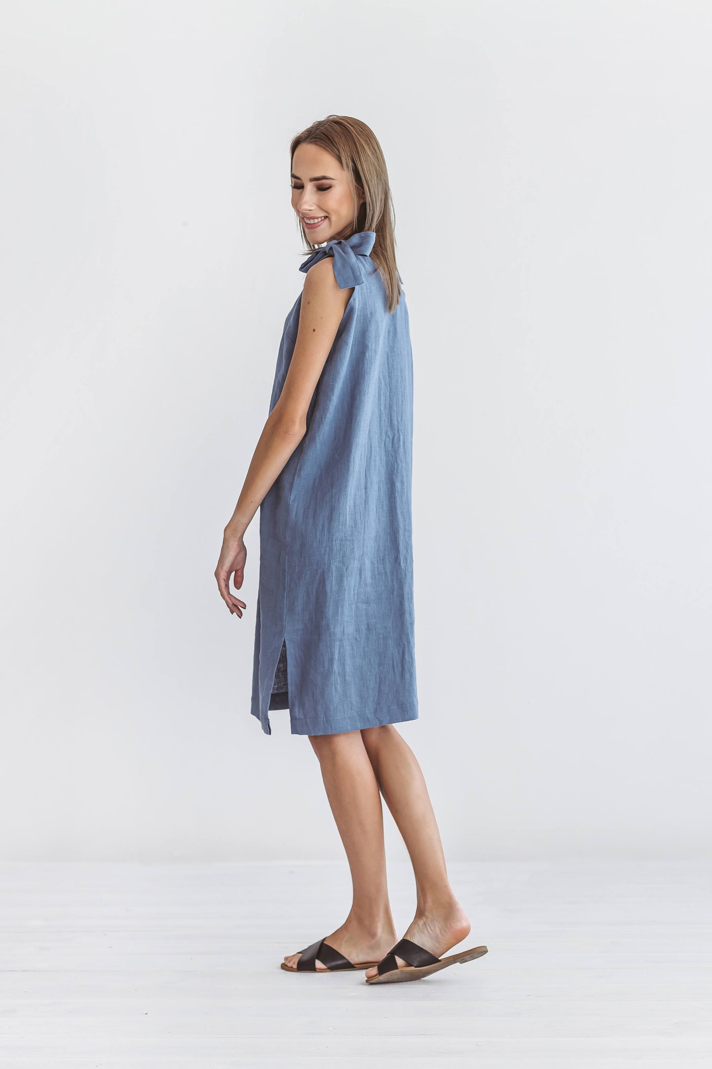 Jeans blue linen dress clean side profile view showing shoulder ties, handmade linen dress slow fashion