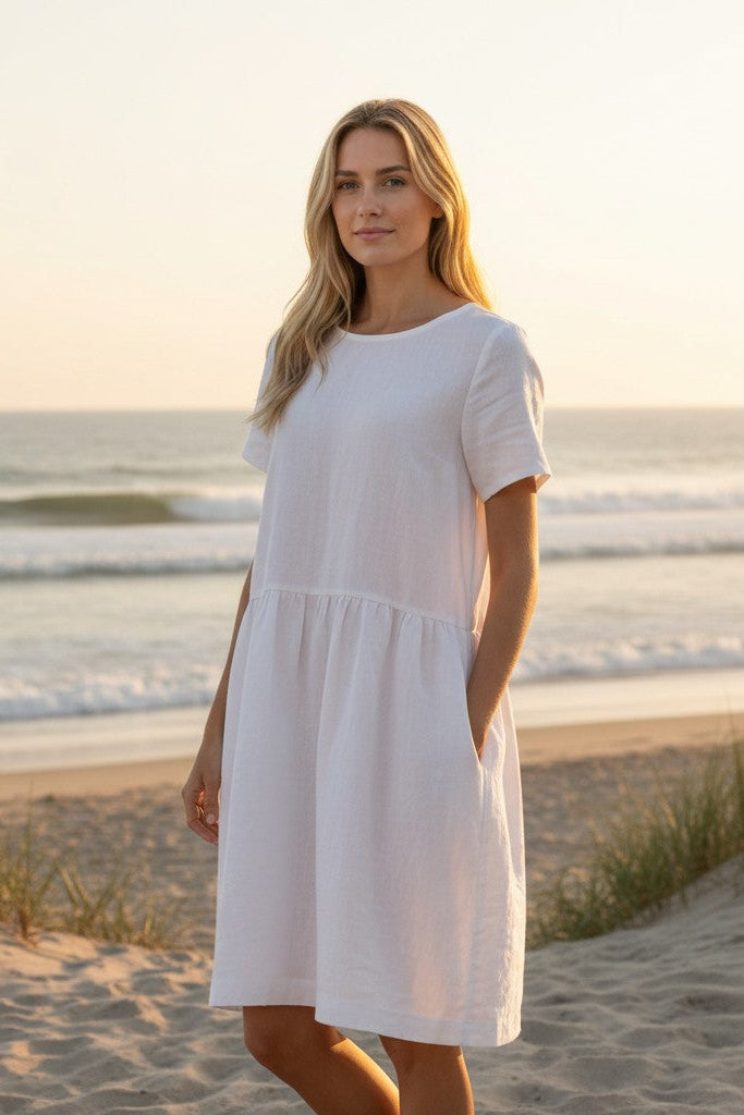 Amelia linen dress – white, standing pose with pockets