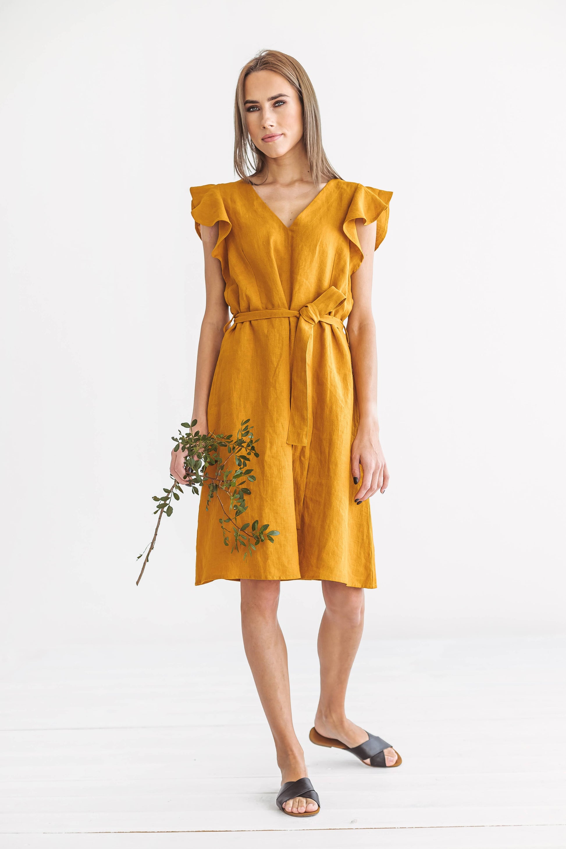 ANGELINA mustard linen dress full front view holding flower handmade linen dress slow fashion