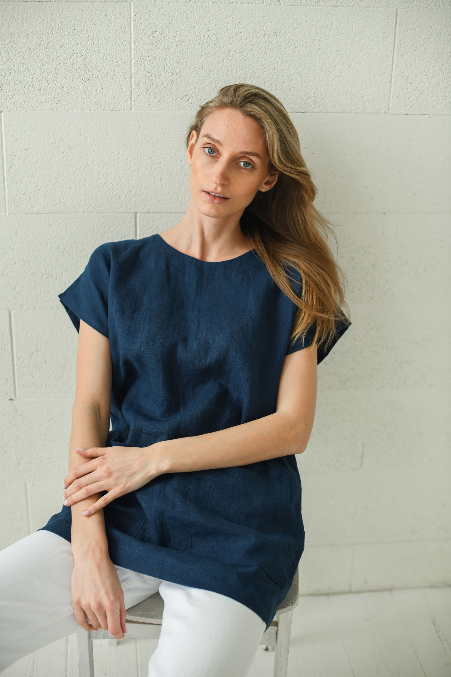 Evelyn linen top with sitting relaxed pose, handmade linen top slow fashion