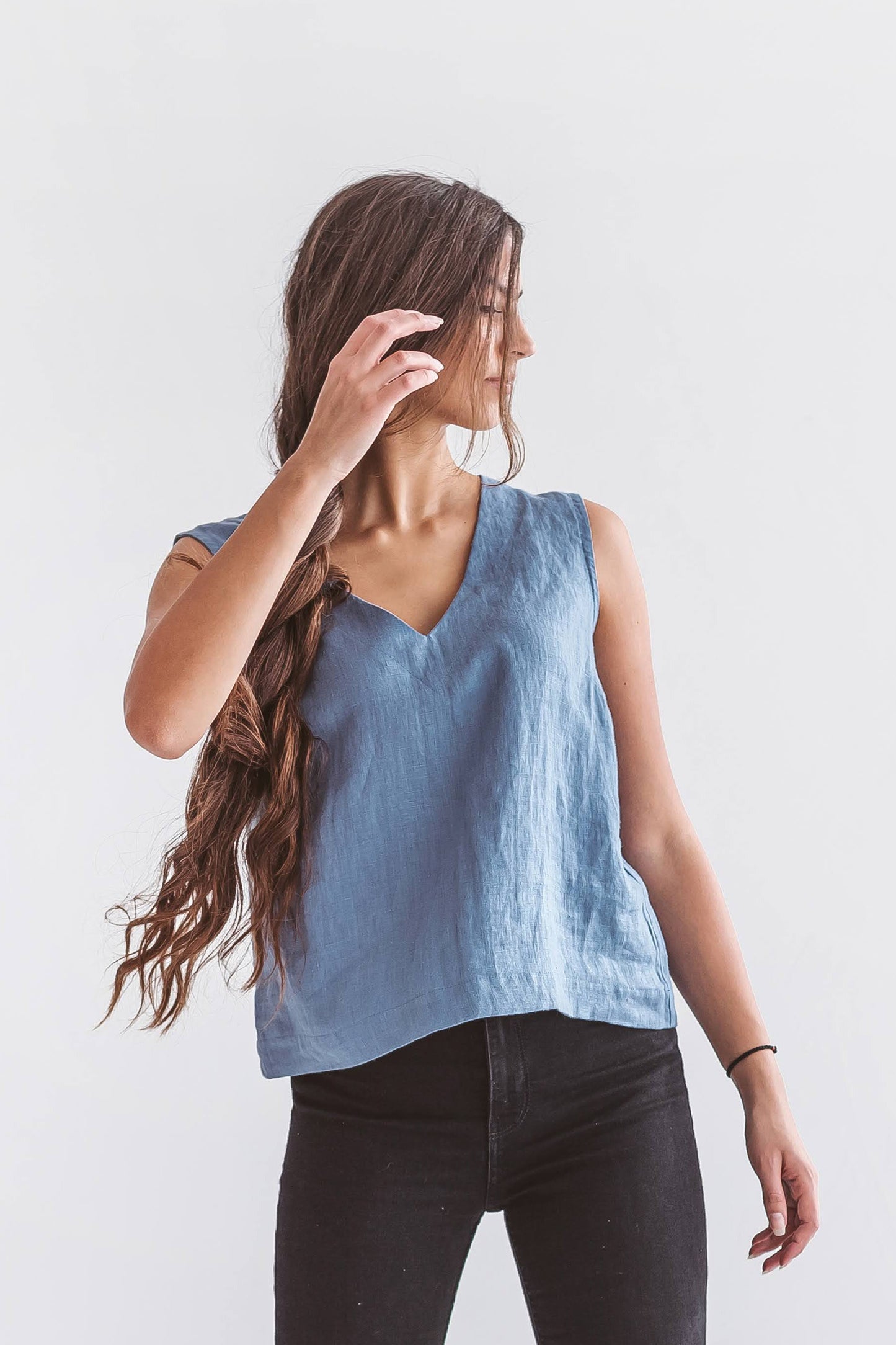 Natural linen sleeveless top styled with casual minimal outfit, breathable eco-friendly slow fashion apparel