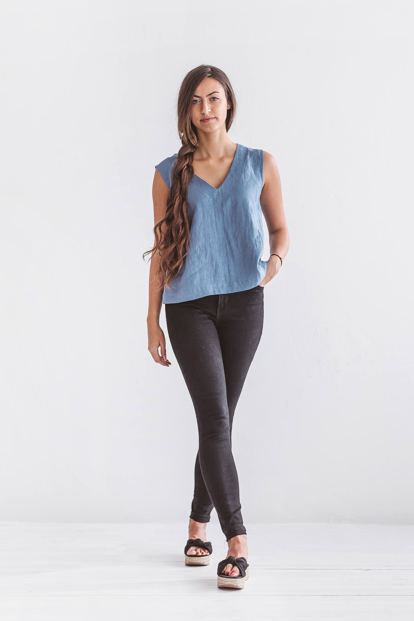 Eco-friendly sleeveless linen blouse in a relaxed fit, shown in a casual everyday slow fashion look