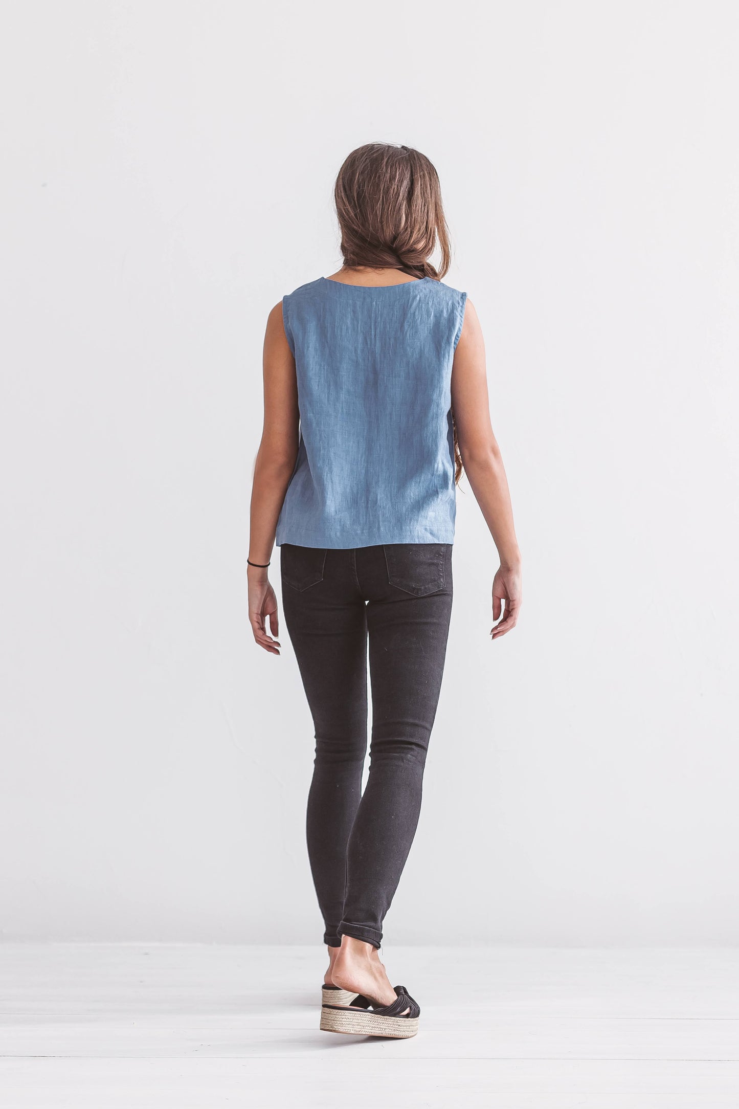 Minimalist women’s linen top styled with leggings, comfortable slow fashion outfit in natural light