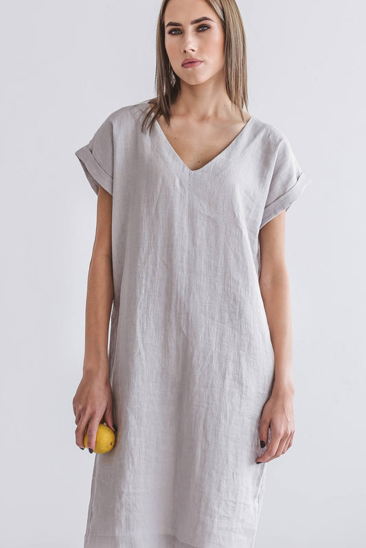 Front view of linen midi dress with V-neckline, relaxed sleeves, and straight silhouette.