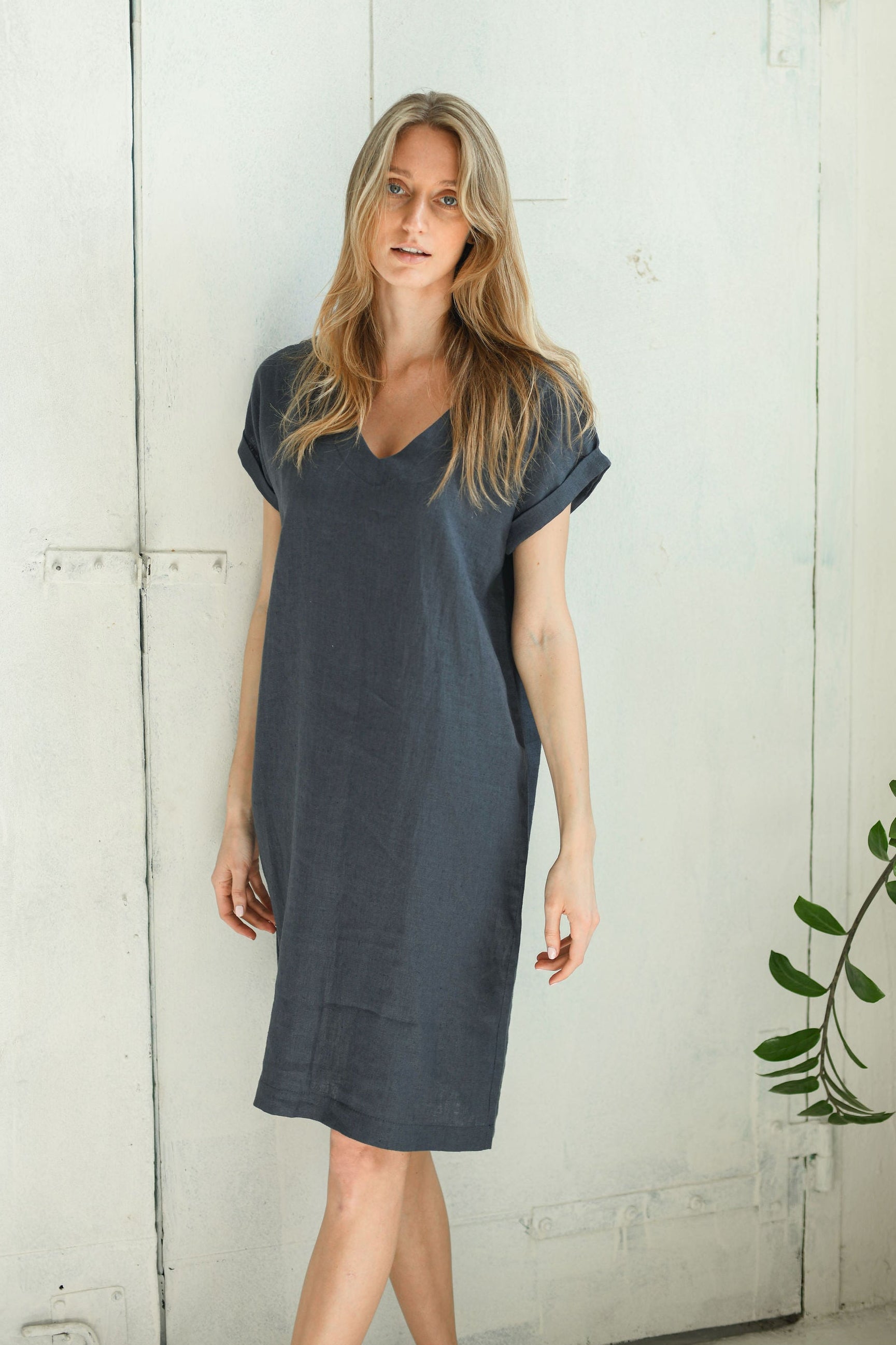 Full-length view of linen midi dress with V-neckline and softly extended sleeves.