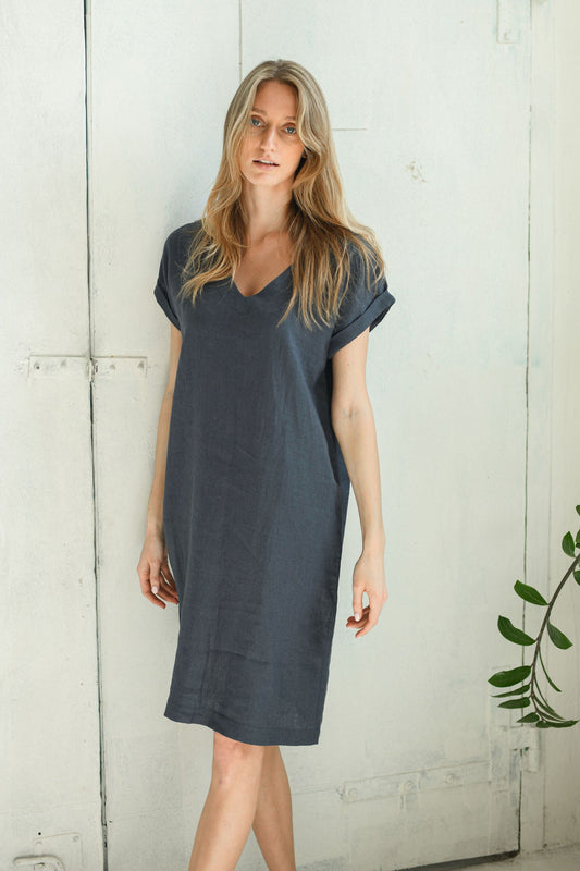 Full-length view of linen midi dress with V-neckline and softly extended sleeves.