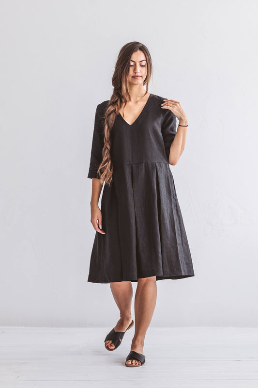 Front view of linen dress featuring a relaxed A-line cut and extended short sleeves.