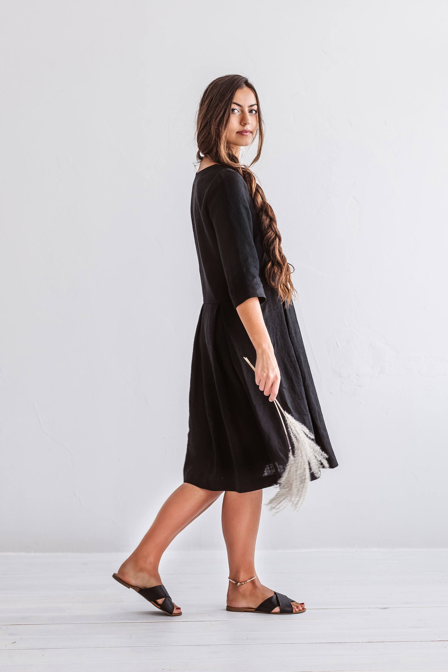 Linen dress captured in gentle walking motion showing natural flow and soft drape.