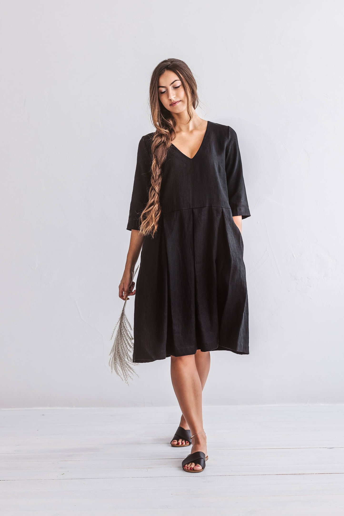 Relaxed standing pose with flowing A-line linen dress and extended short sleeves.