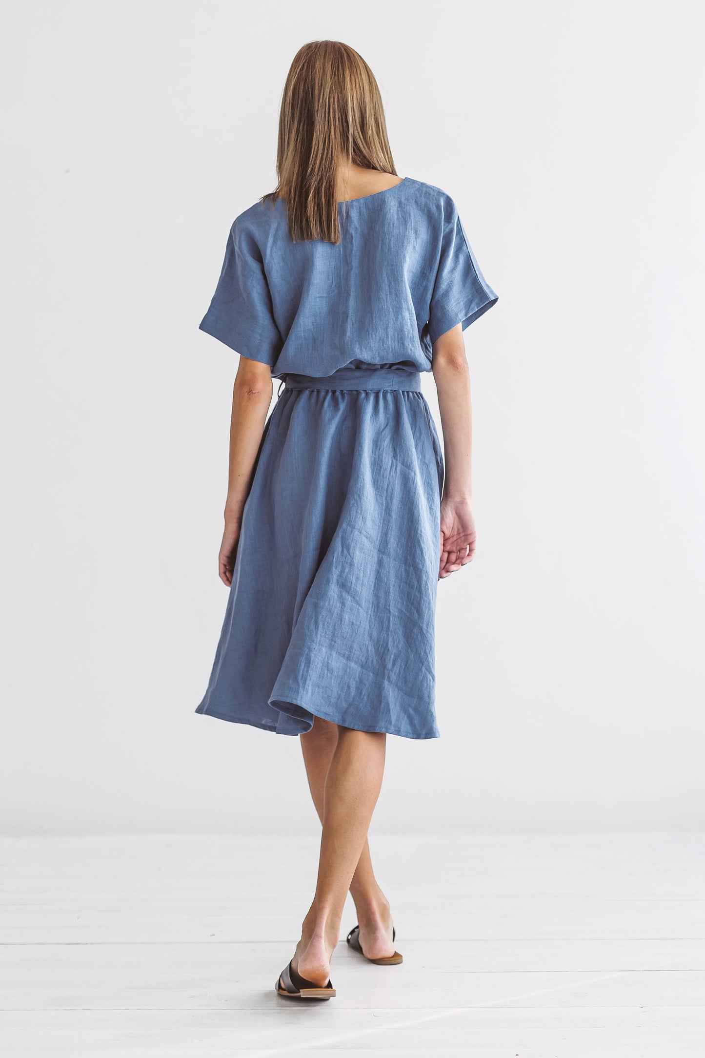 Close-up of the Kate linen dress highlighting round neckline and soft linen texture back view