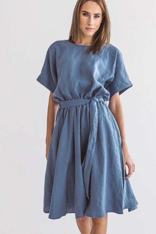 Minimalist studio shot of the Kate linen dress in a relaxed standing pose