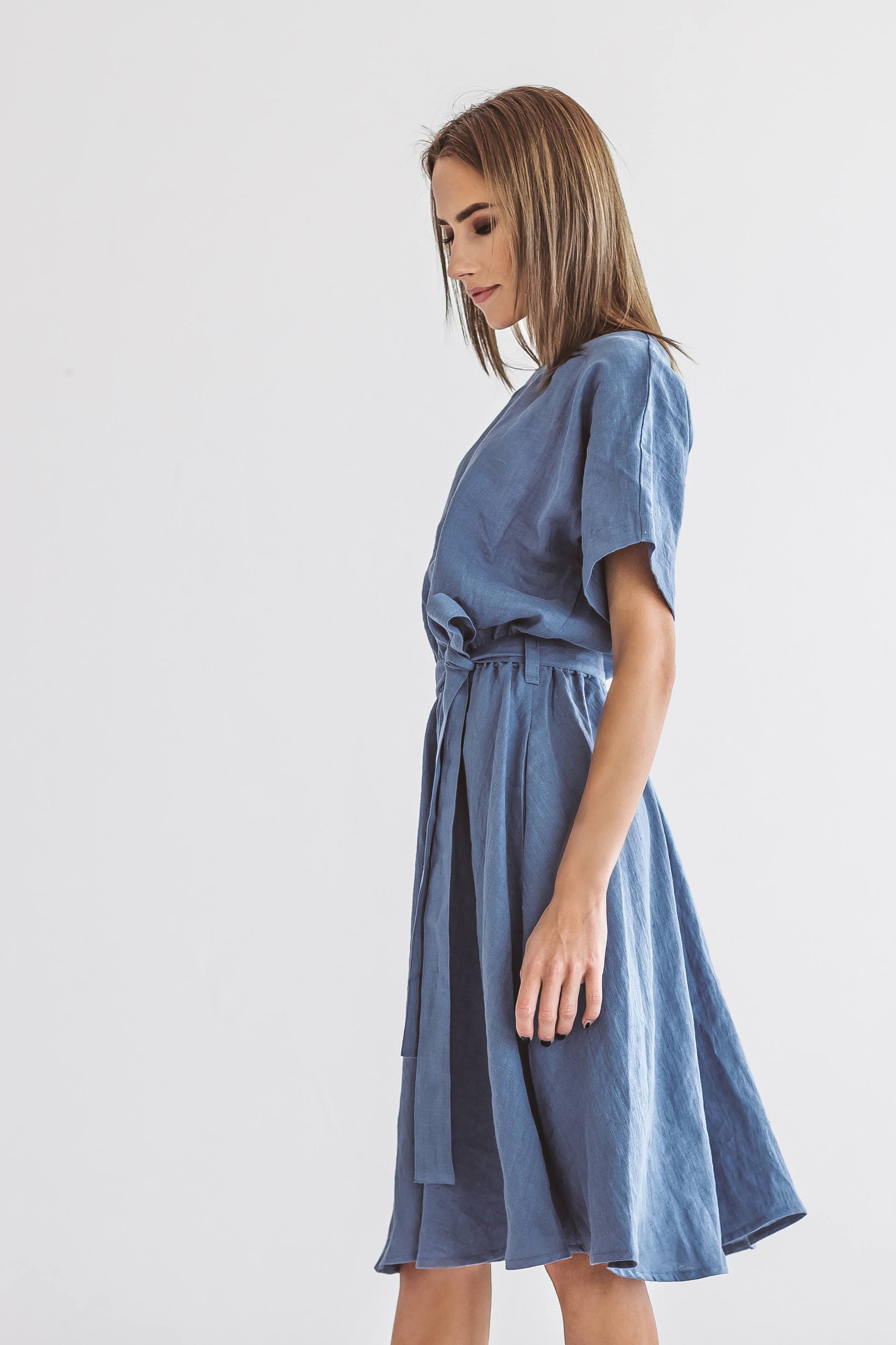 Side view of the Kate linen dress showing relaxed drape and soft gathering at the waist