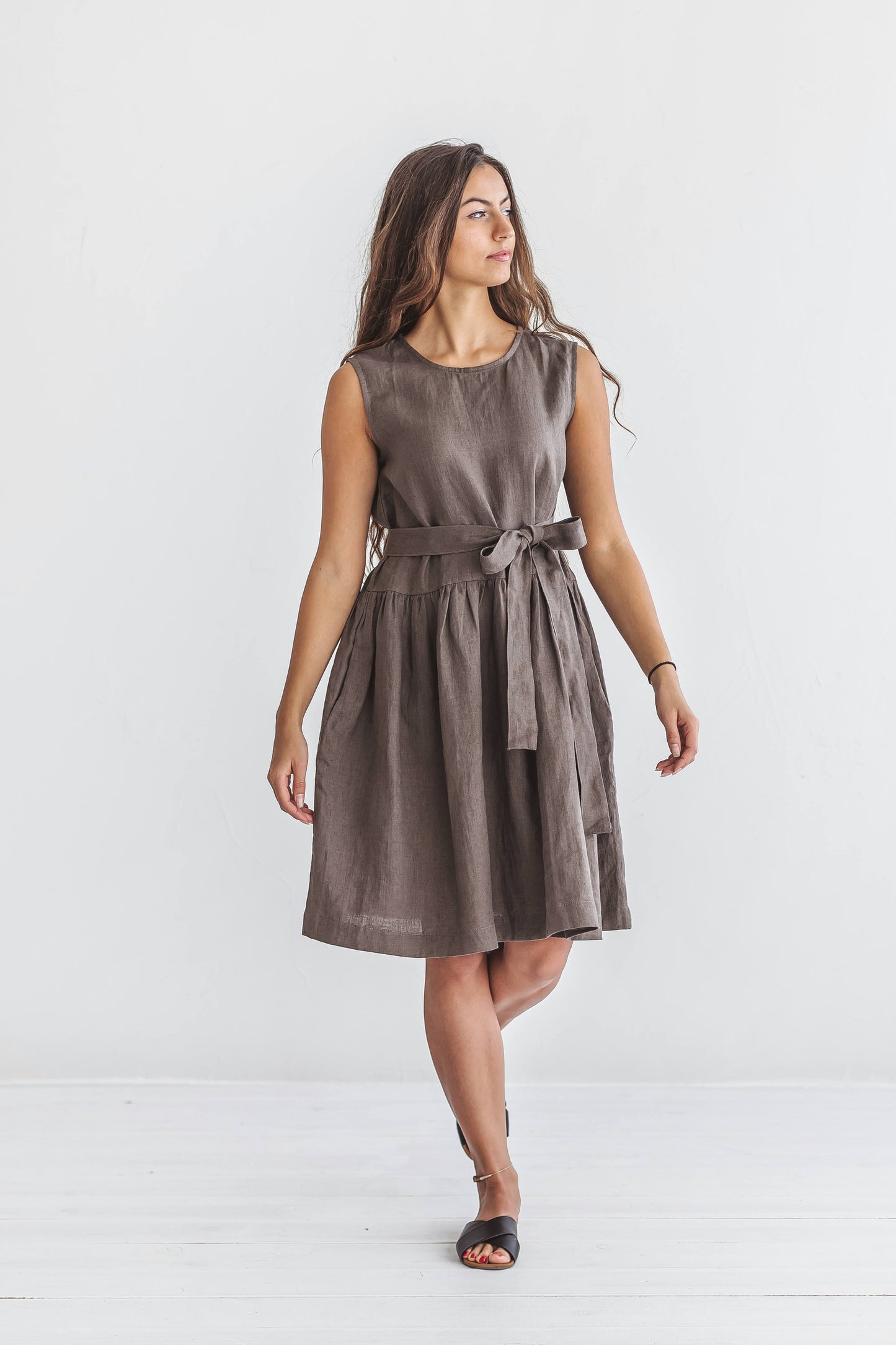 Model walking in the beige Kelly linen dress, skirt moving gently with natural motion