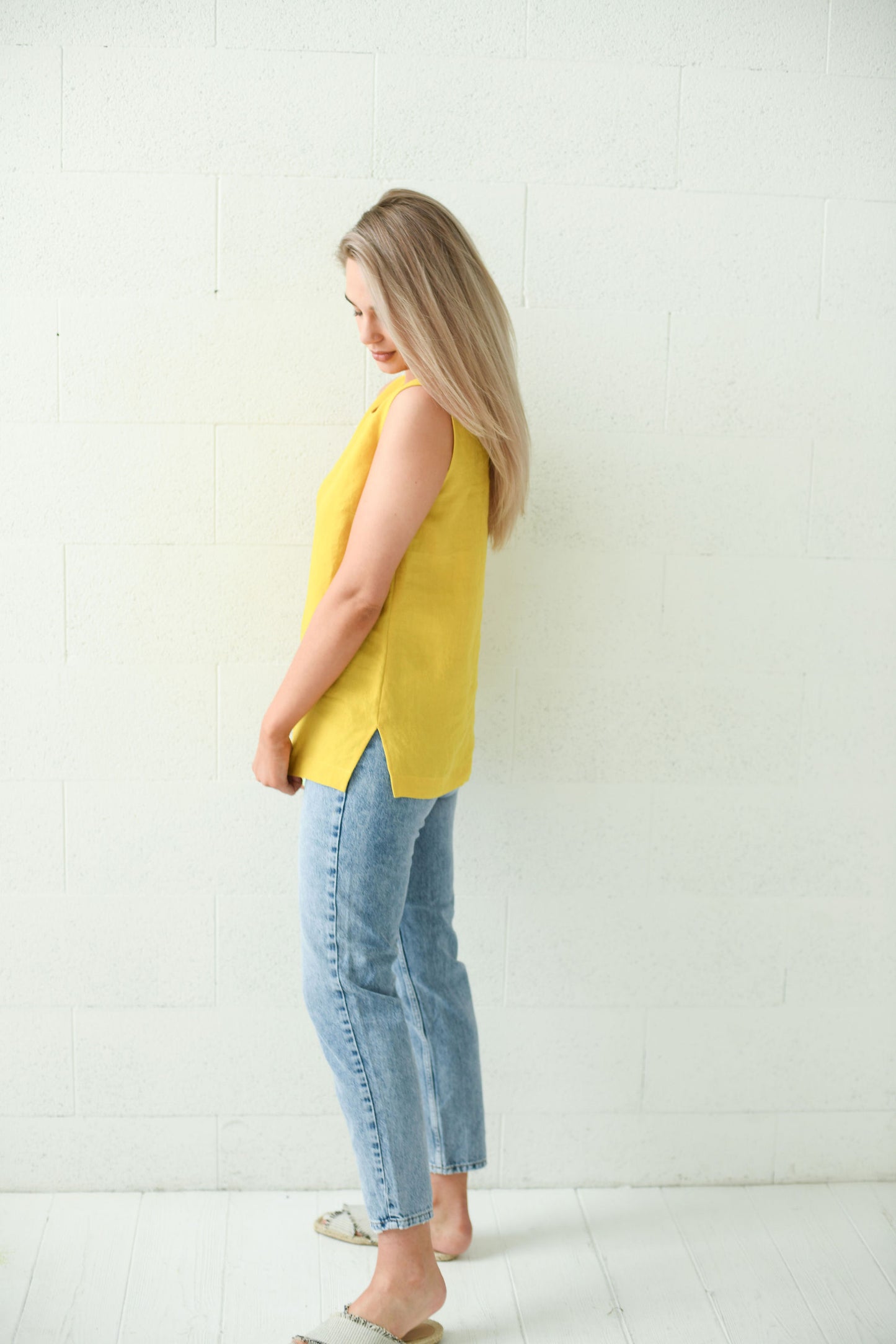 Back view of the Laura linen top showing relaxed straight cut and side slits