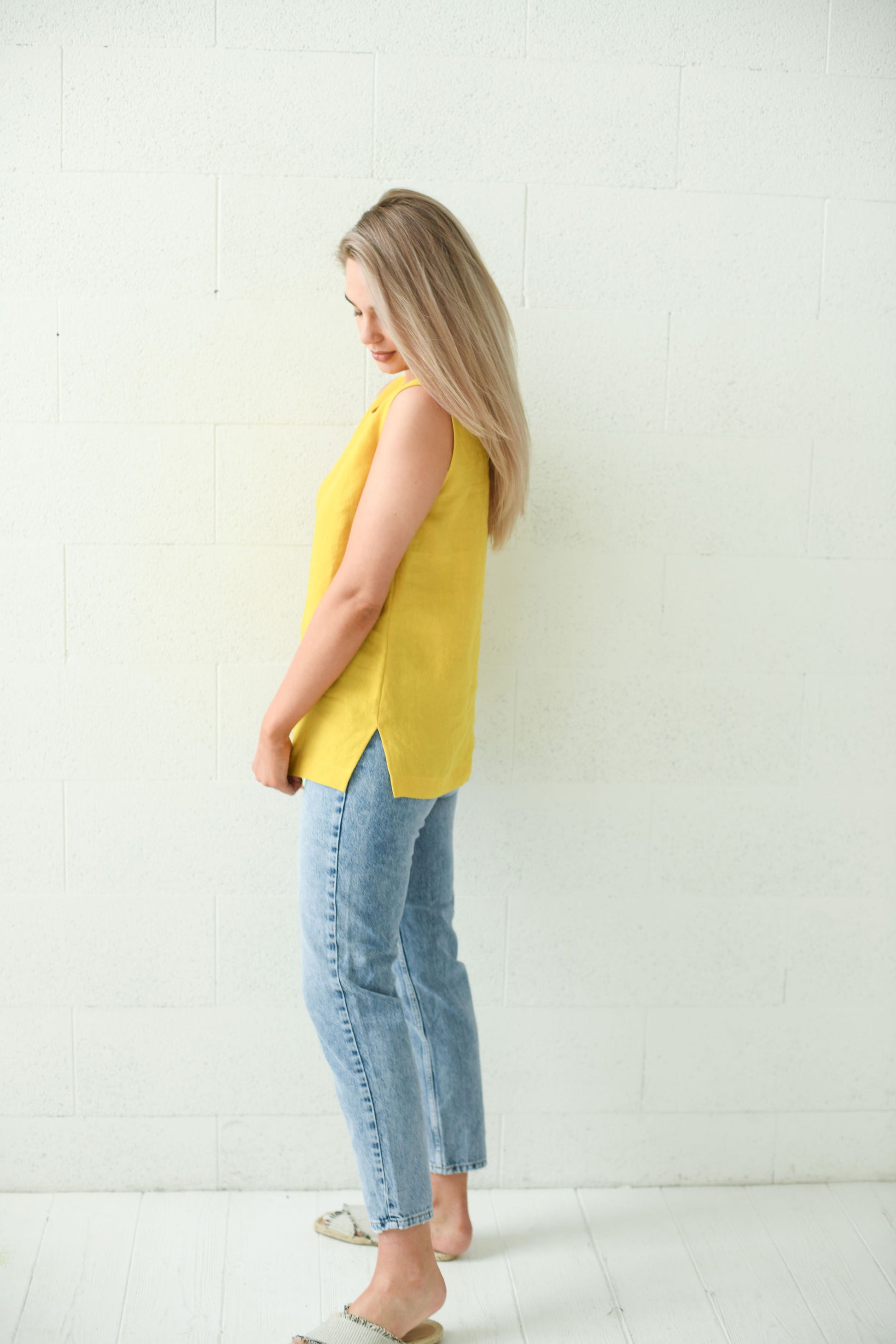 Back view of the Laura linen top showing relaxed straight cut and side slits