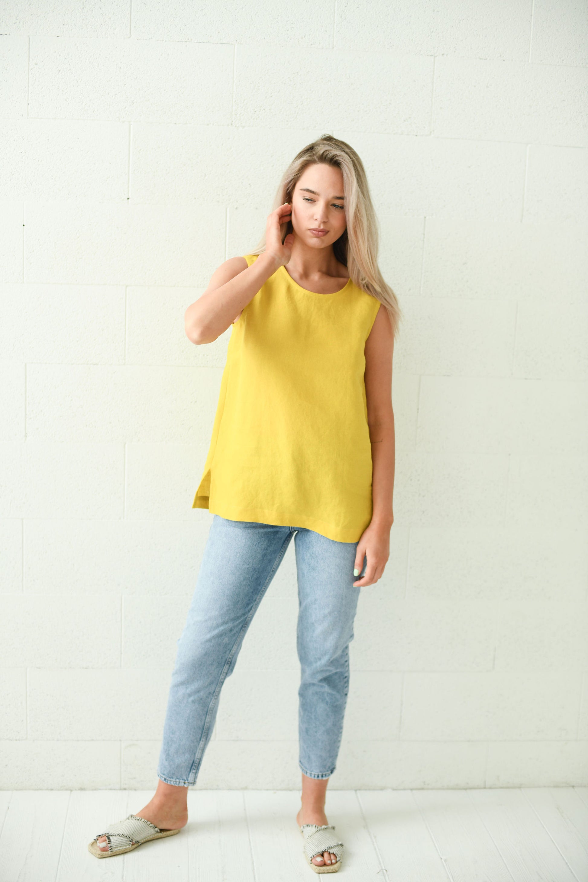 Side view of the Laura linen top showing longer hemline and side slit detail