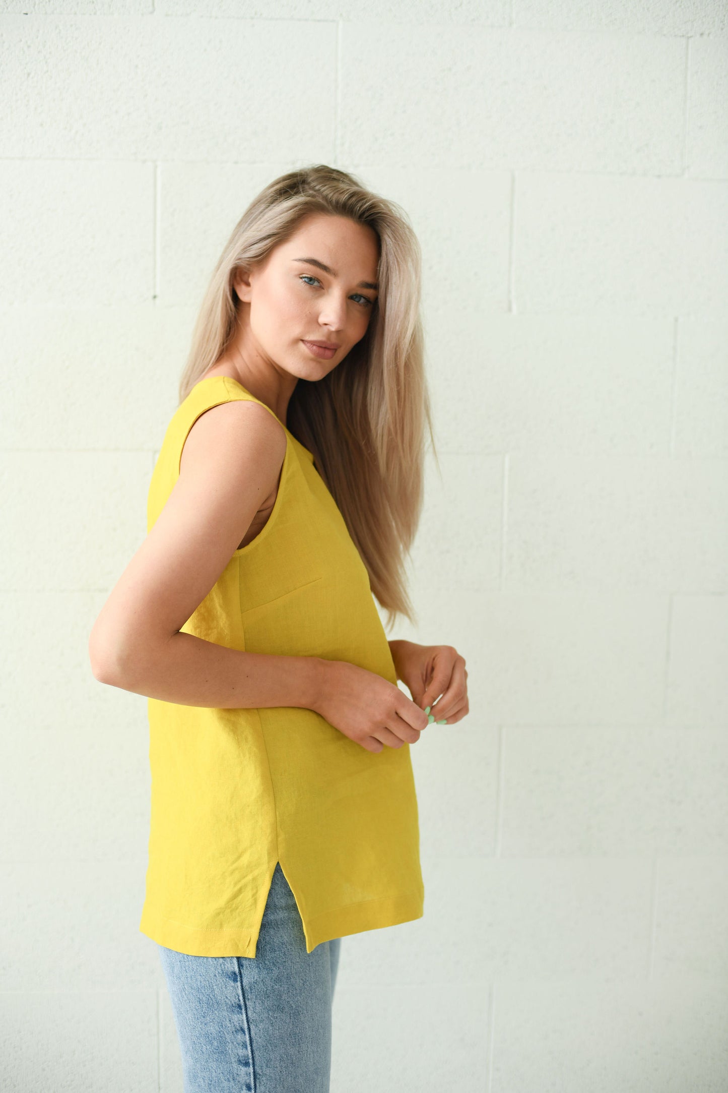 Studio shot of the Laura linen top highlighting clean lines and airy drape