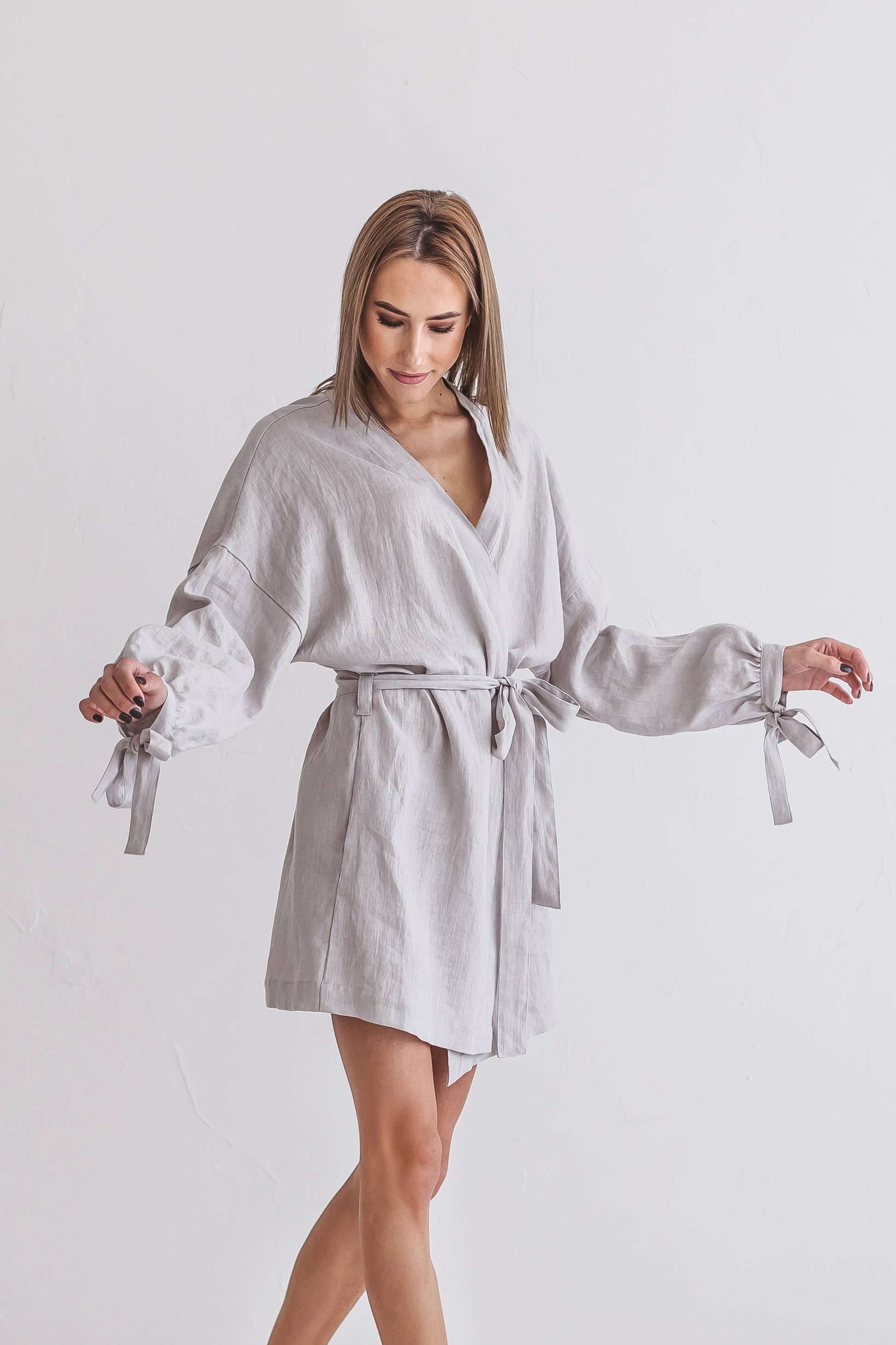 Woman in movement with linen kimono robe, handmade linen clothing slow fashion
