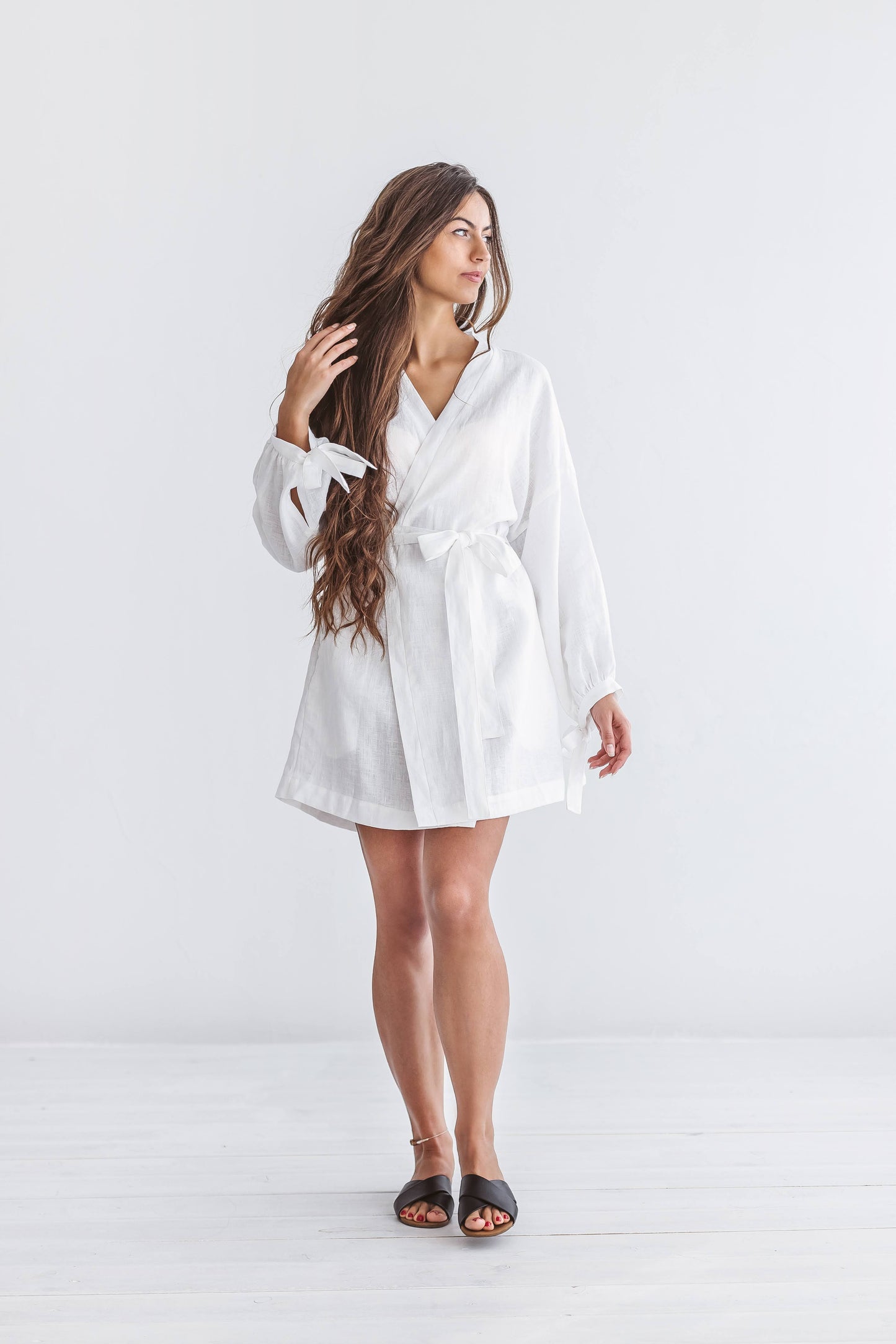 Minimalist studio pose of the Lauren linen robe with belt and relaxed drape
