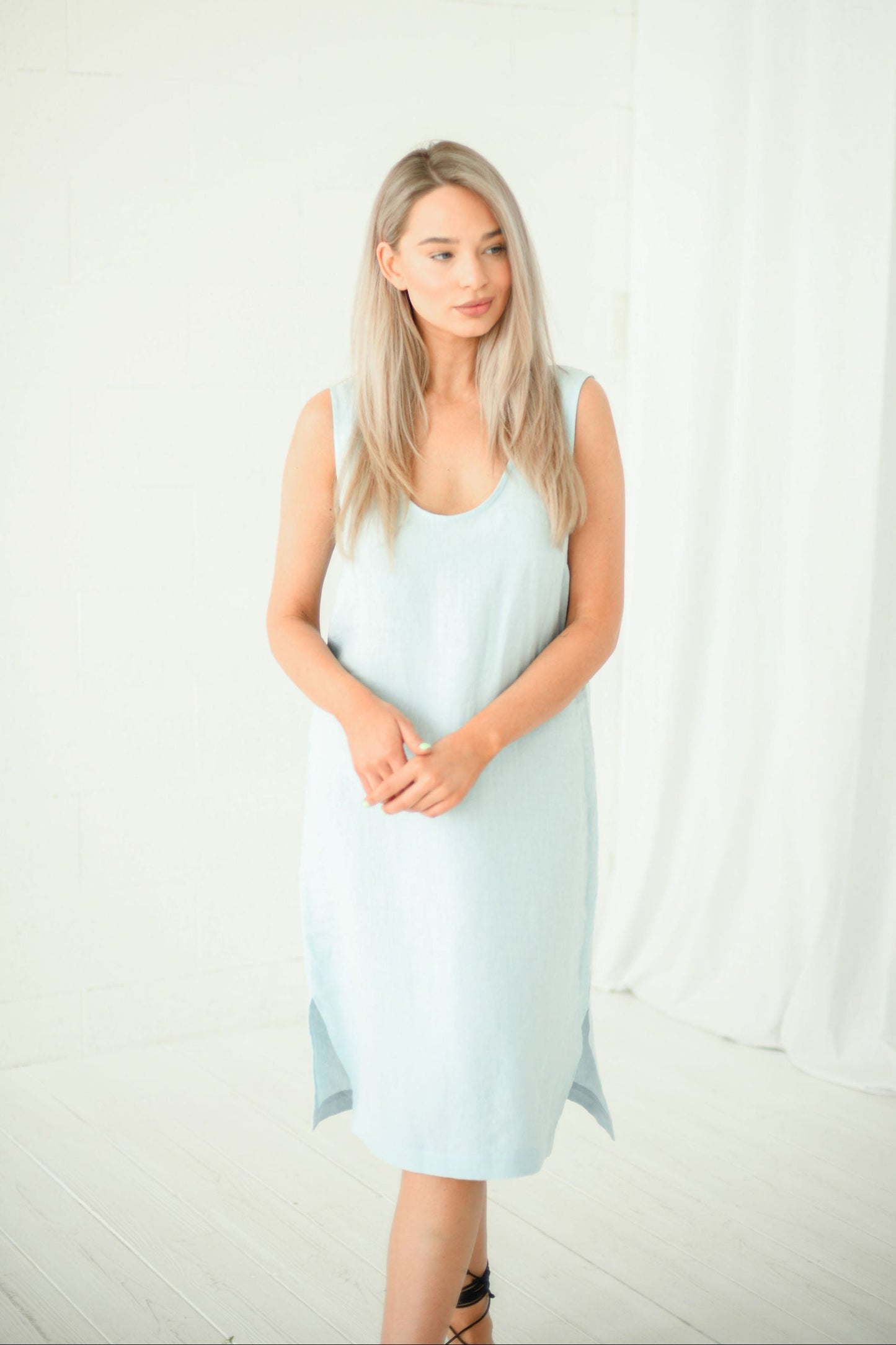 Light blue linen midi dress in natural light showing relaxed fit, handmade linen dress slow fashion