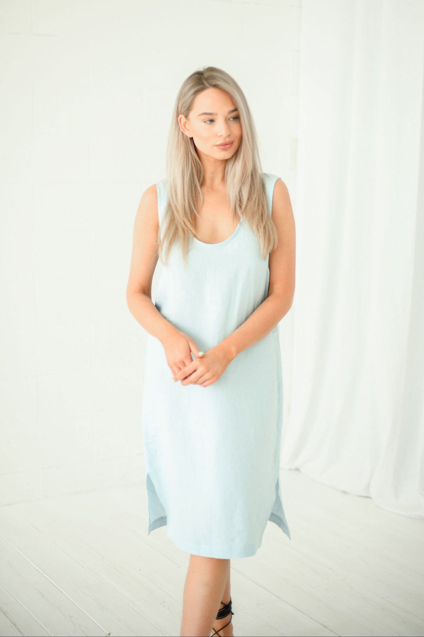 Light blue linen midi dress in natural light showing relaxed fit, handmade linen dress slow fashion