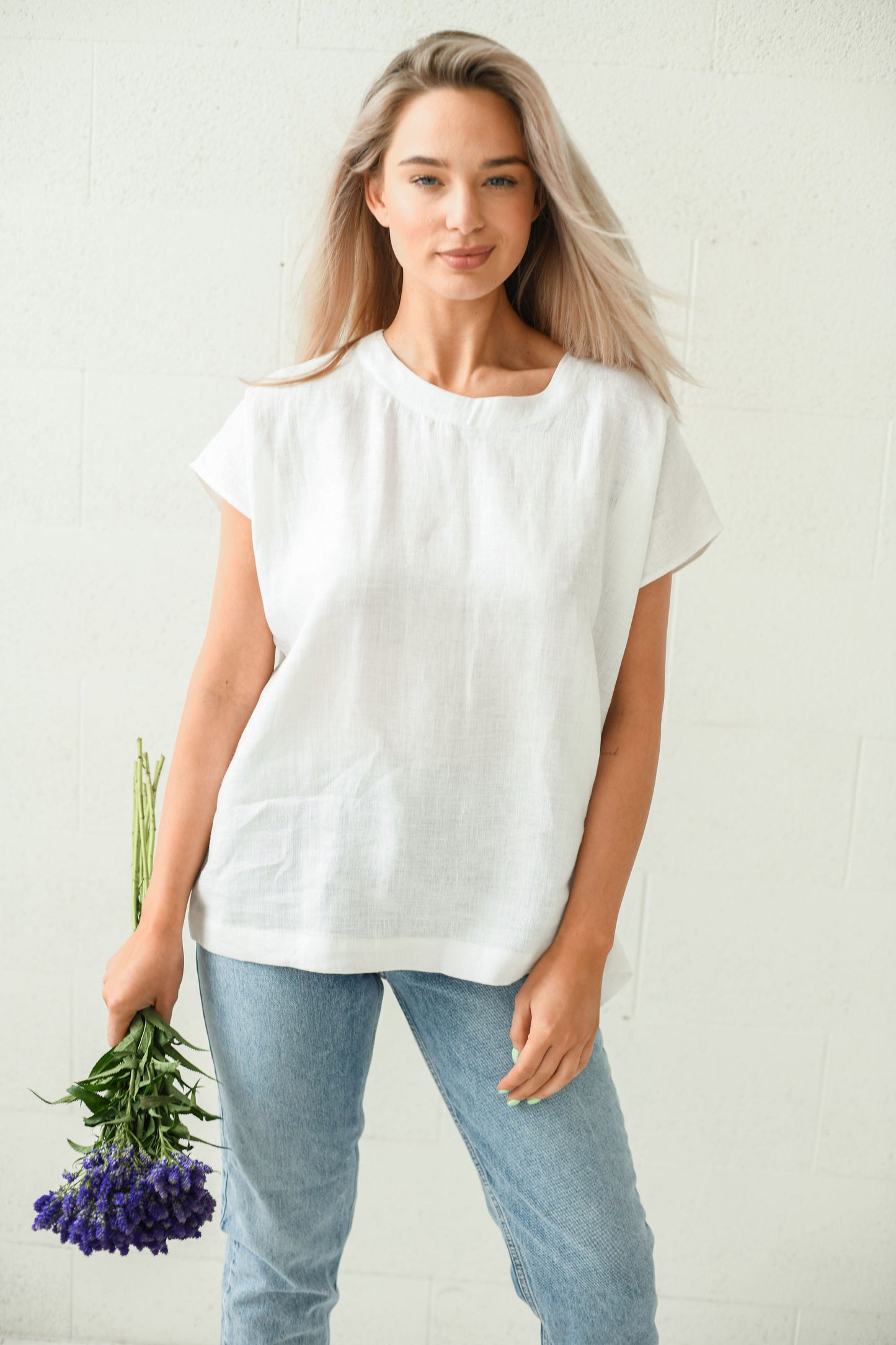White linen top full-body view with relaxed posture minimalist style, handmade linen top slow fashion